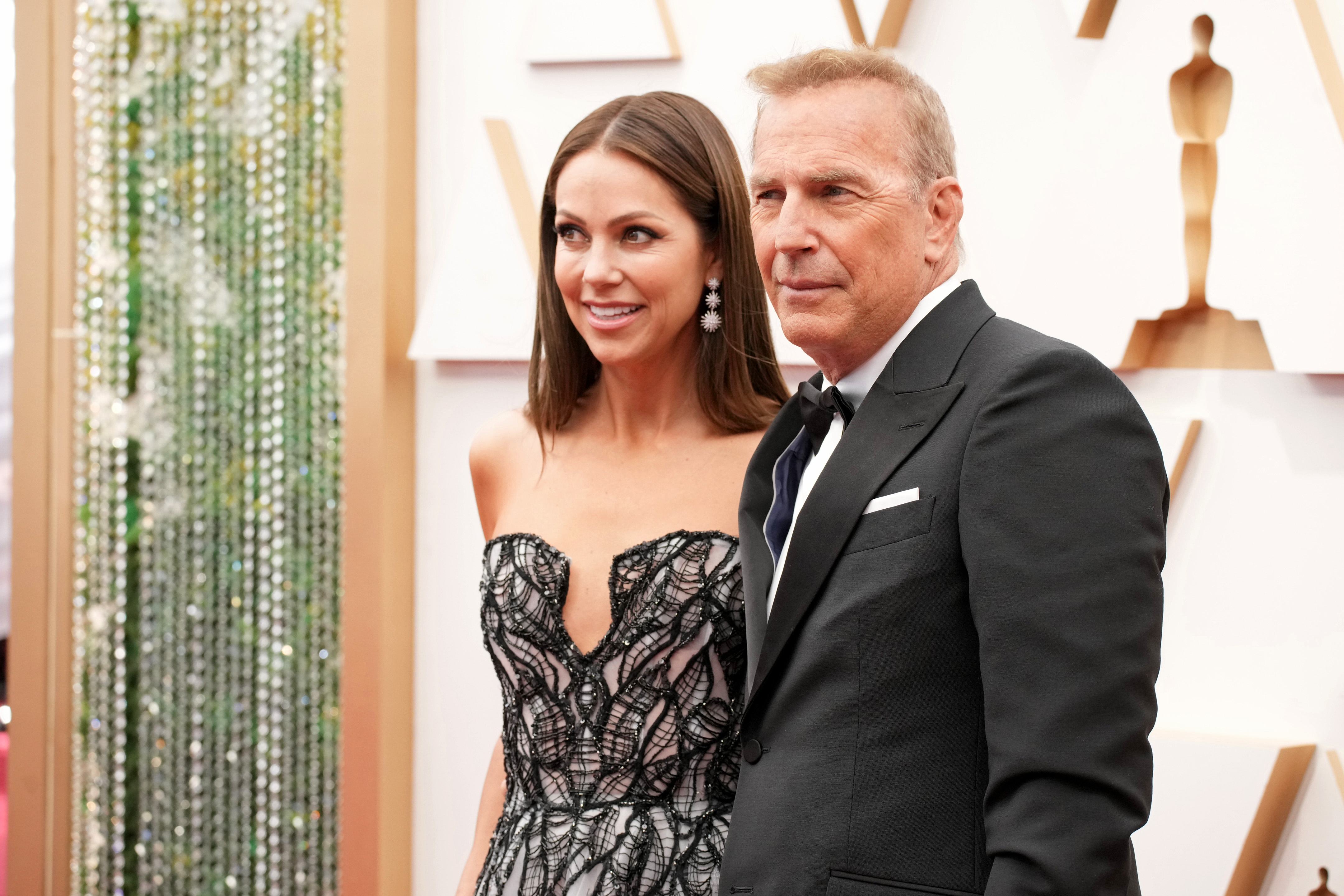 Christine Baumgartner and Kevin Costner at the 94th Annual Academy Awards in Hollywood, California on March 27, 2022 | Source: Getty Images