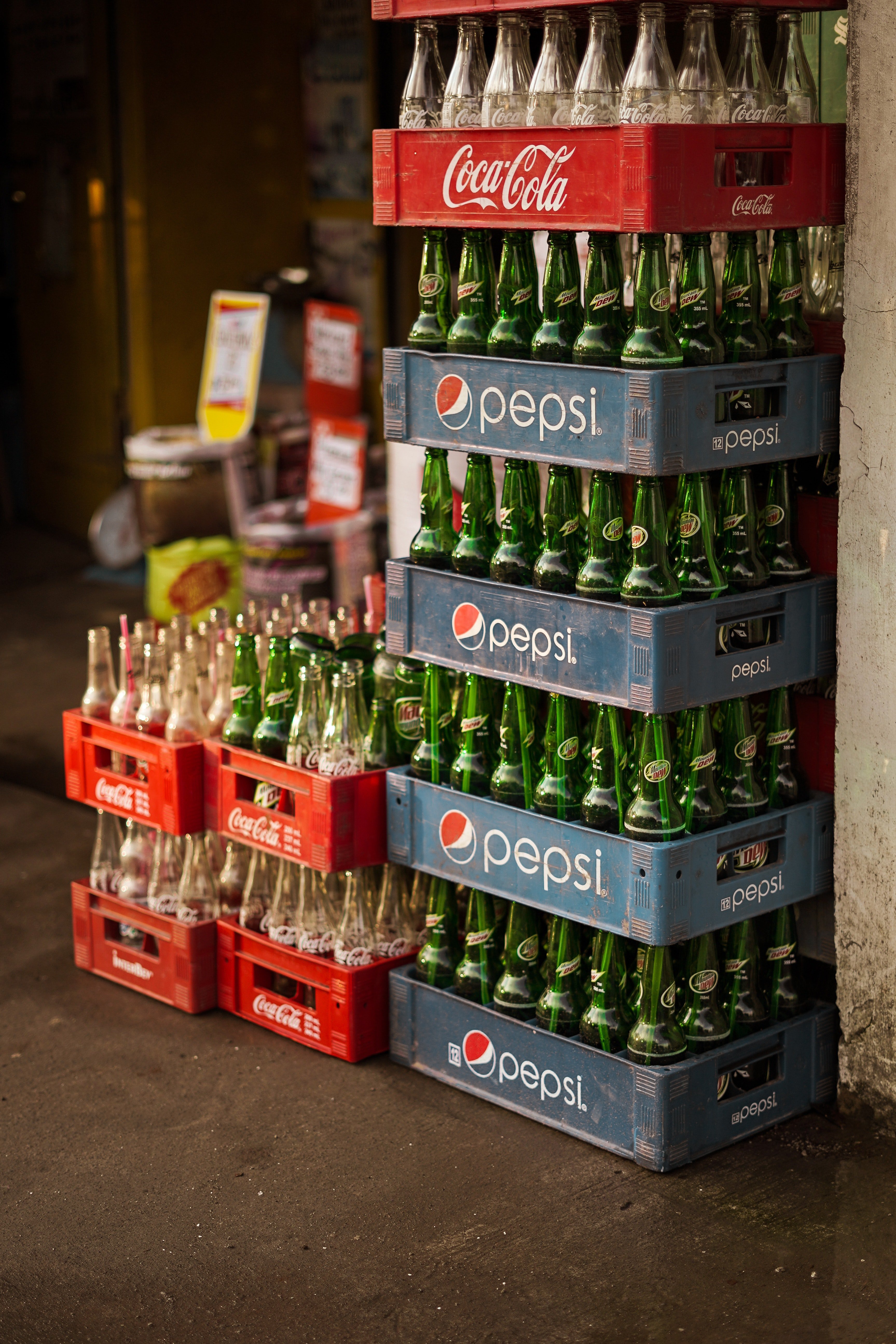 Soft drink bottles placed in racks inside a store. | Photo: Pexels