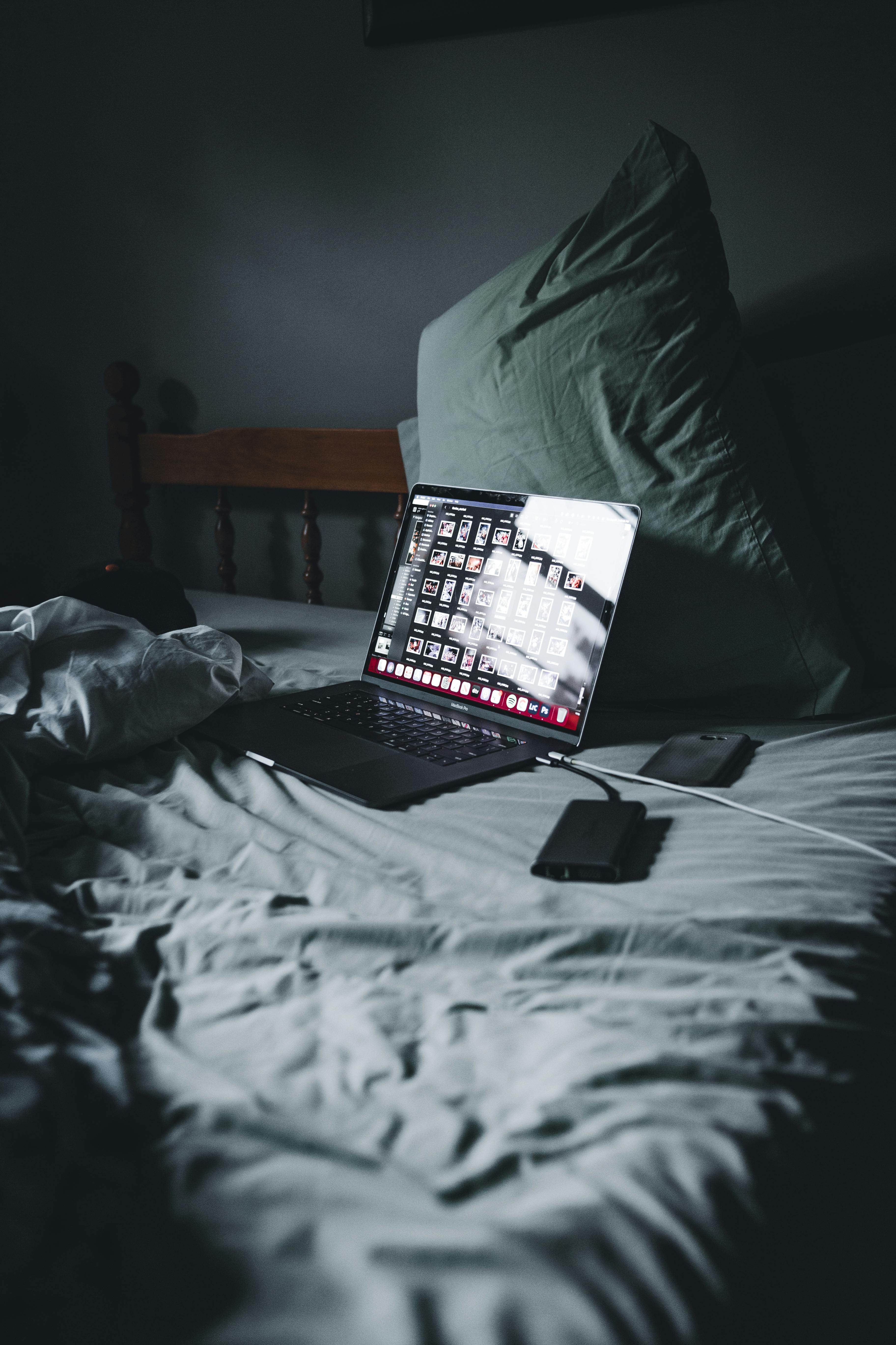 Electronics on top of a bed | Source: Pexels