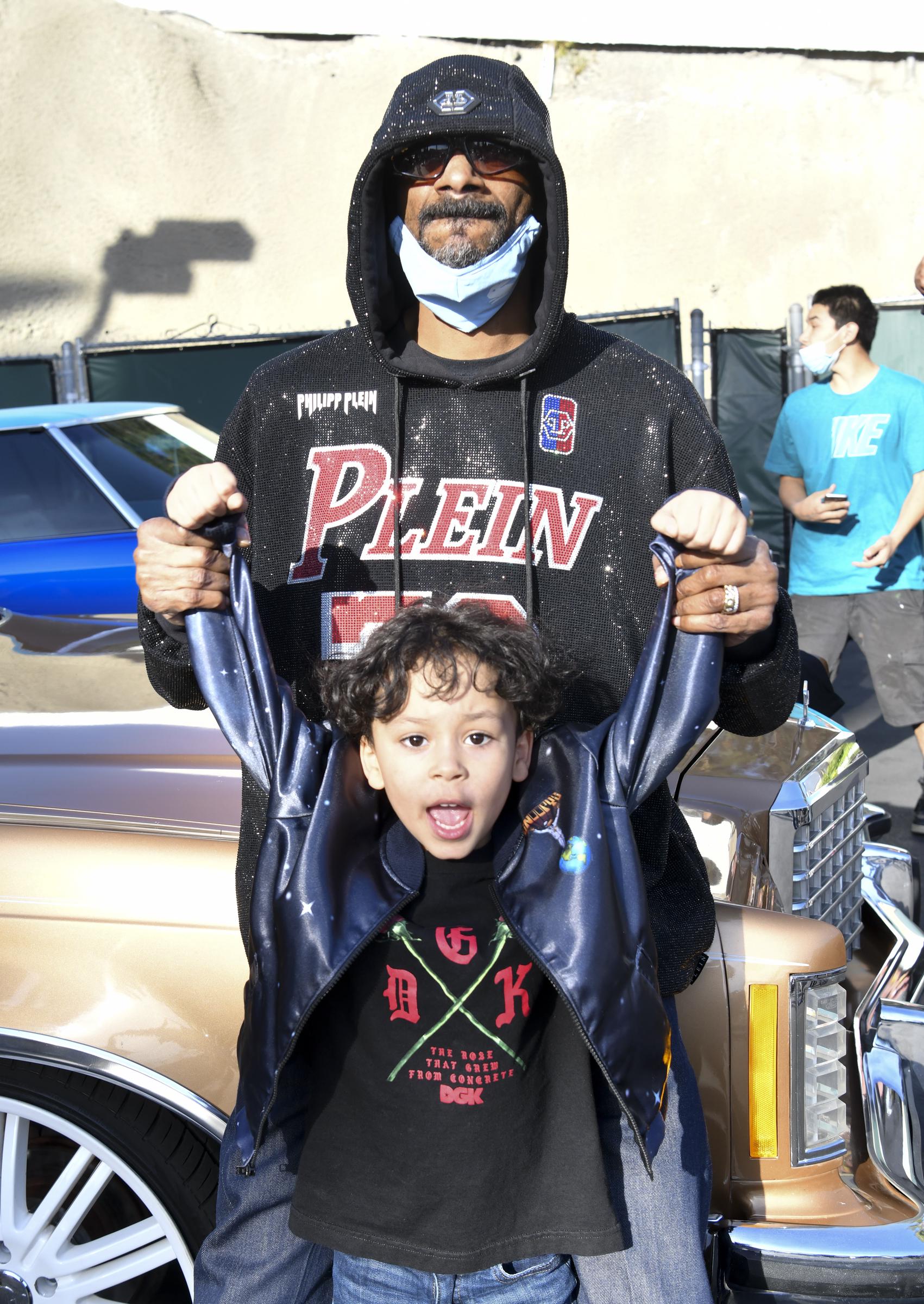 Snoop Dogg and Zion Broadus pose for portrait during classic car meet on February 28, 2021, in West Hollywood, California. | Source: Getty Images