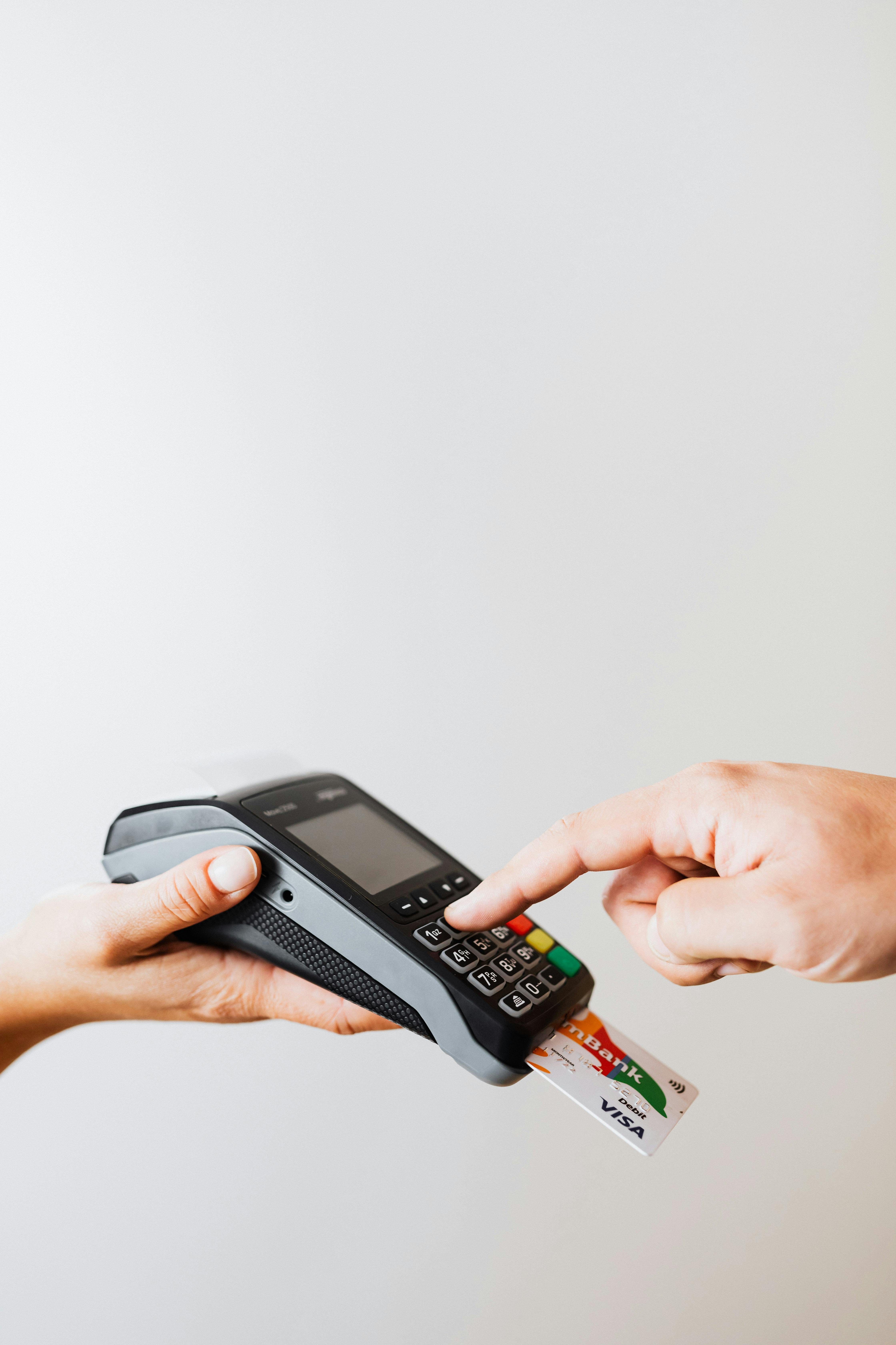 A person inputting their pin on a card machine | Source: Pexels