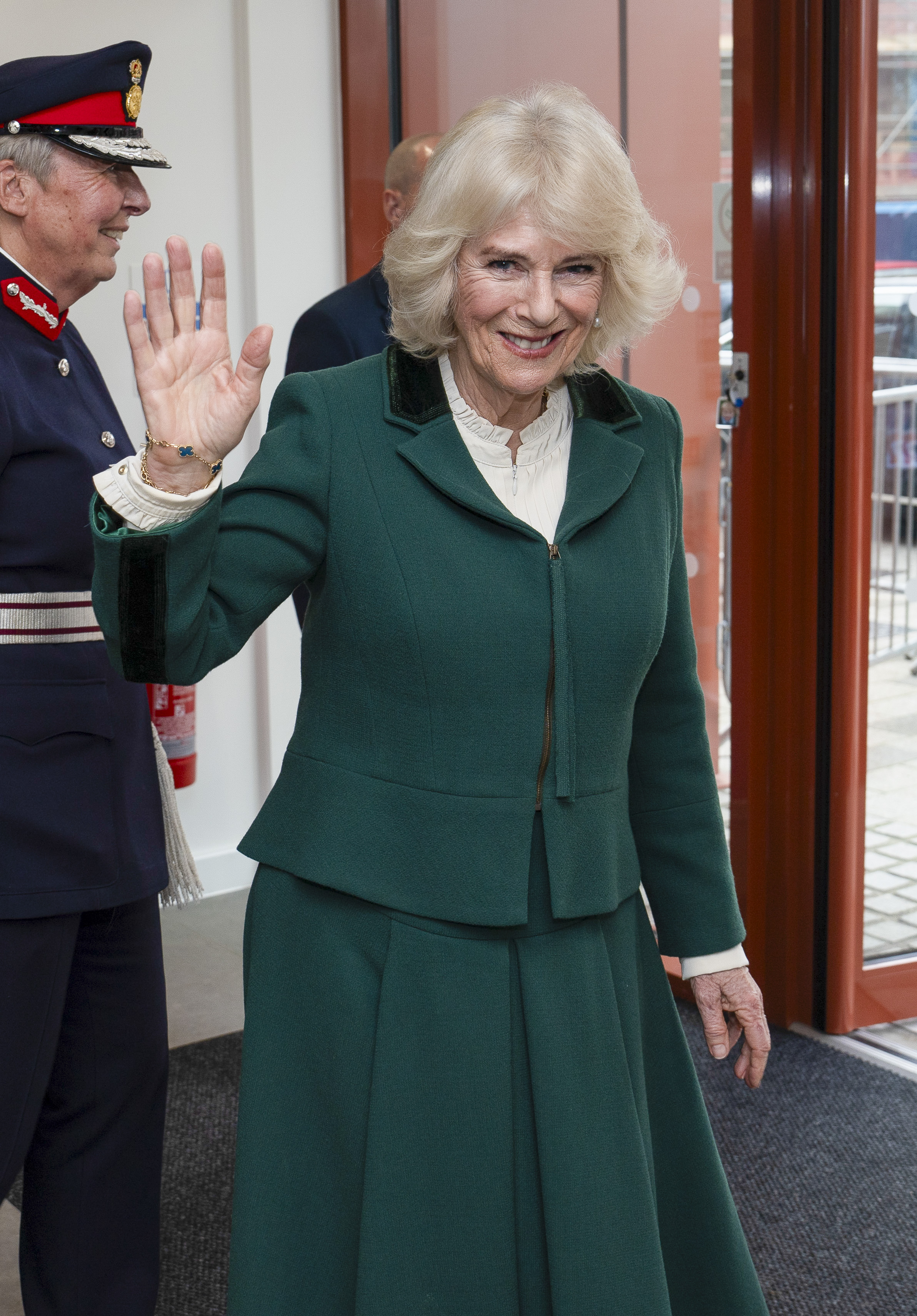 Queen Camilla waves during a visit to the newly opened Meadows Community Centre on February 2, 2024 in Cambridge, England | Source: Getty Images