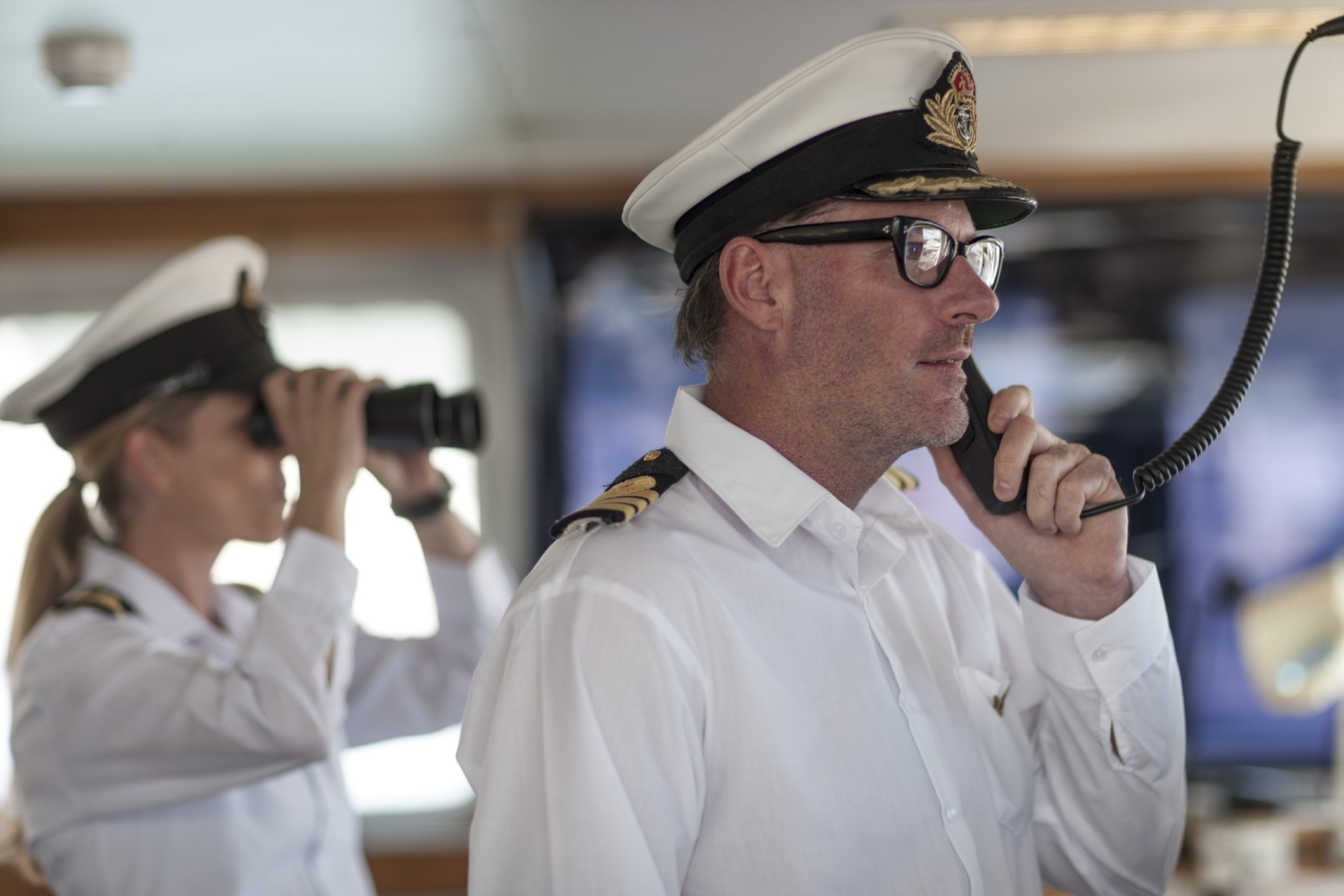 Ship captain on bridge talking on radio | Photo: Getty Images