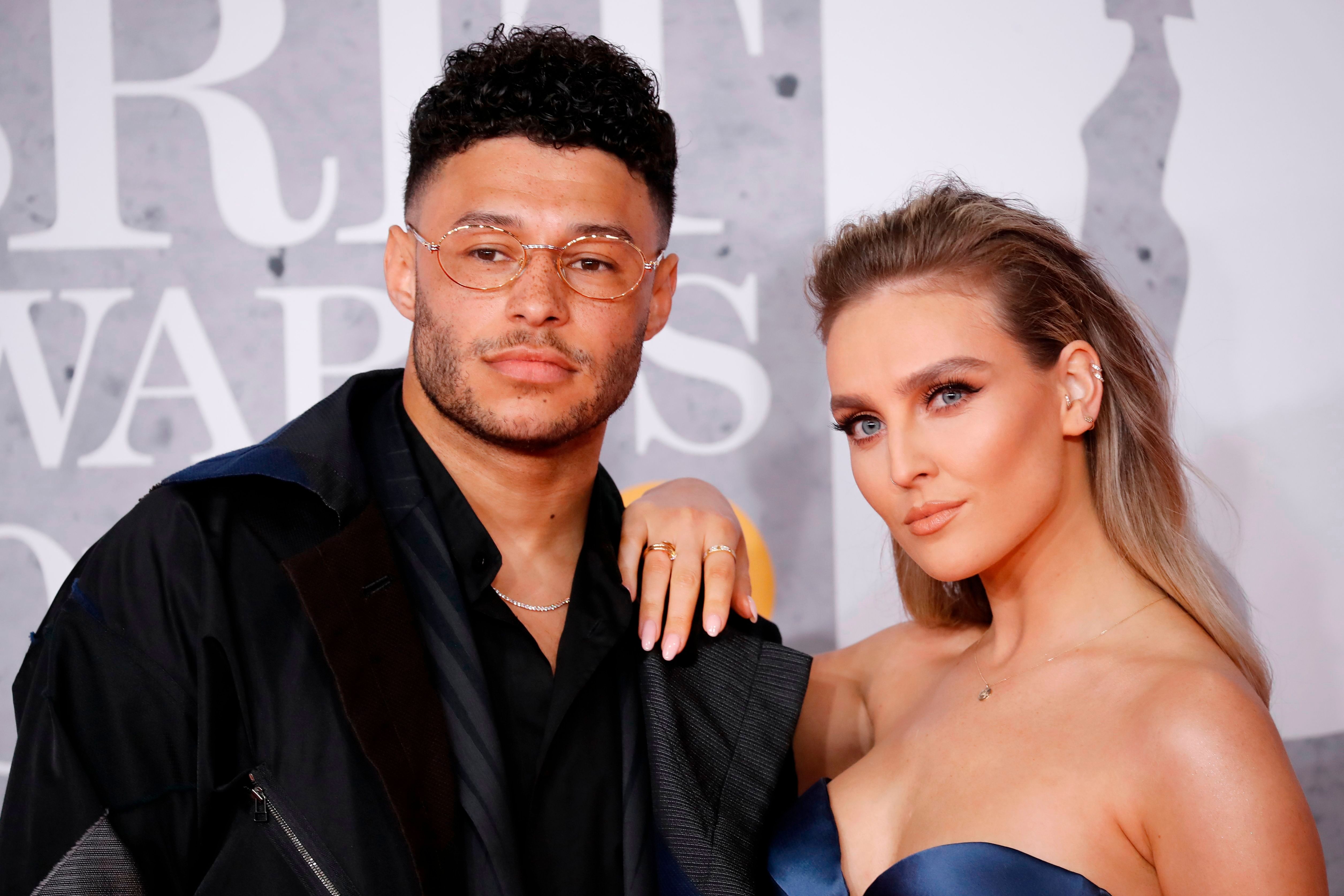 Alex Oxlade-Chamberlain and Perrie Edwards at the BRIT Awards in London on February 20, 2019 | Photo: Tolga Akmen/AFP/Getty Images