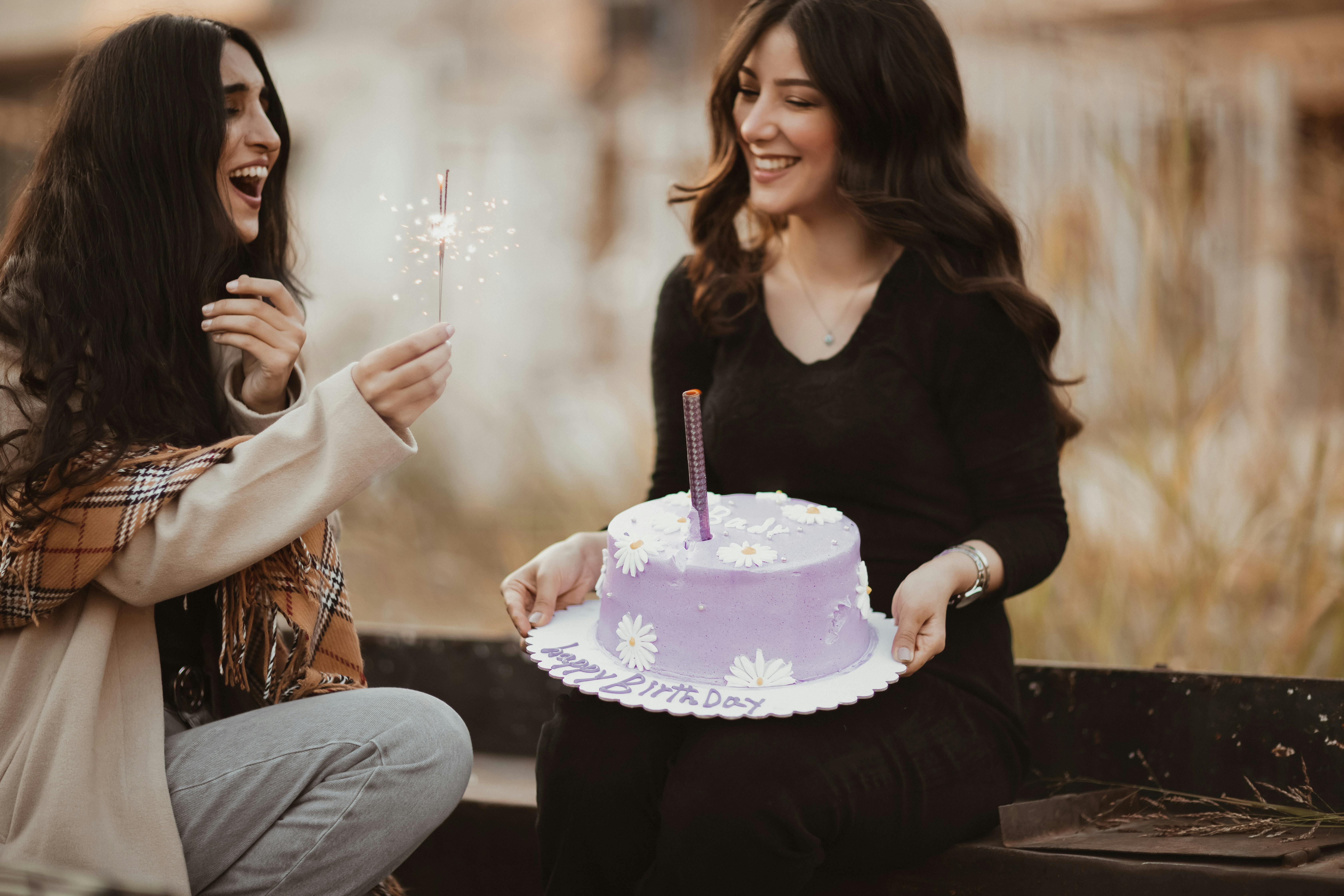 Two happy women with a cake | Source: Pexels