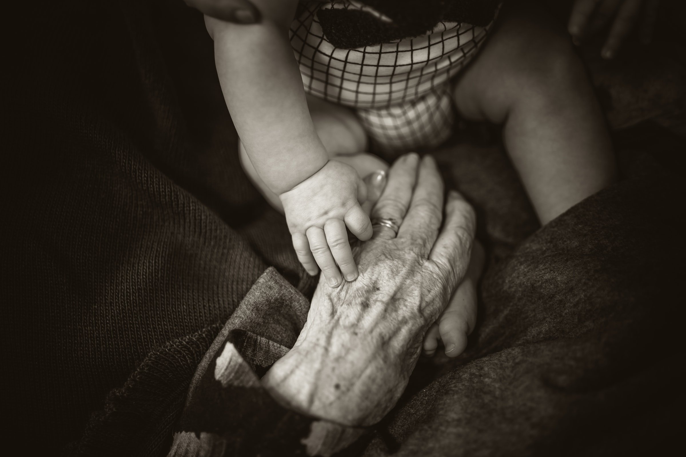 Old woman's hand with a baby's hand. | Source: Unsplash