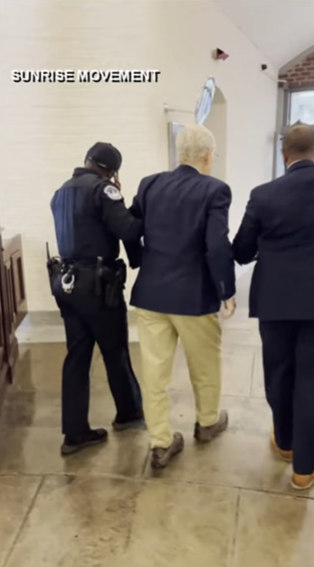 Senator Mitch McConnell is escorted down the hallway by a security and a staff aide following the incident, as posted on October 16, 2025 | Source: YouTube/WHAS11News