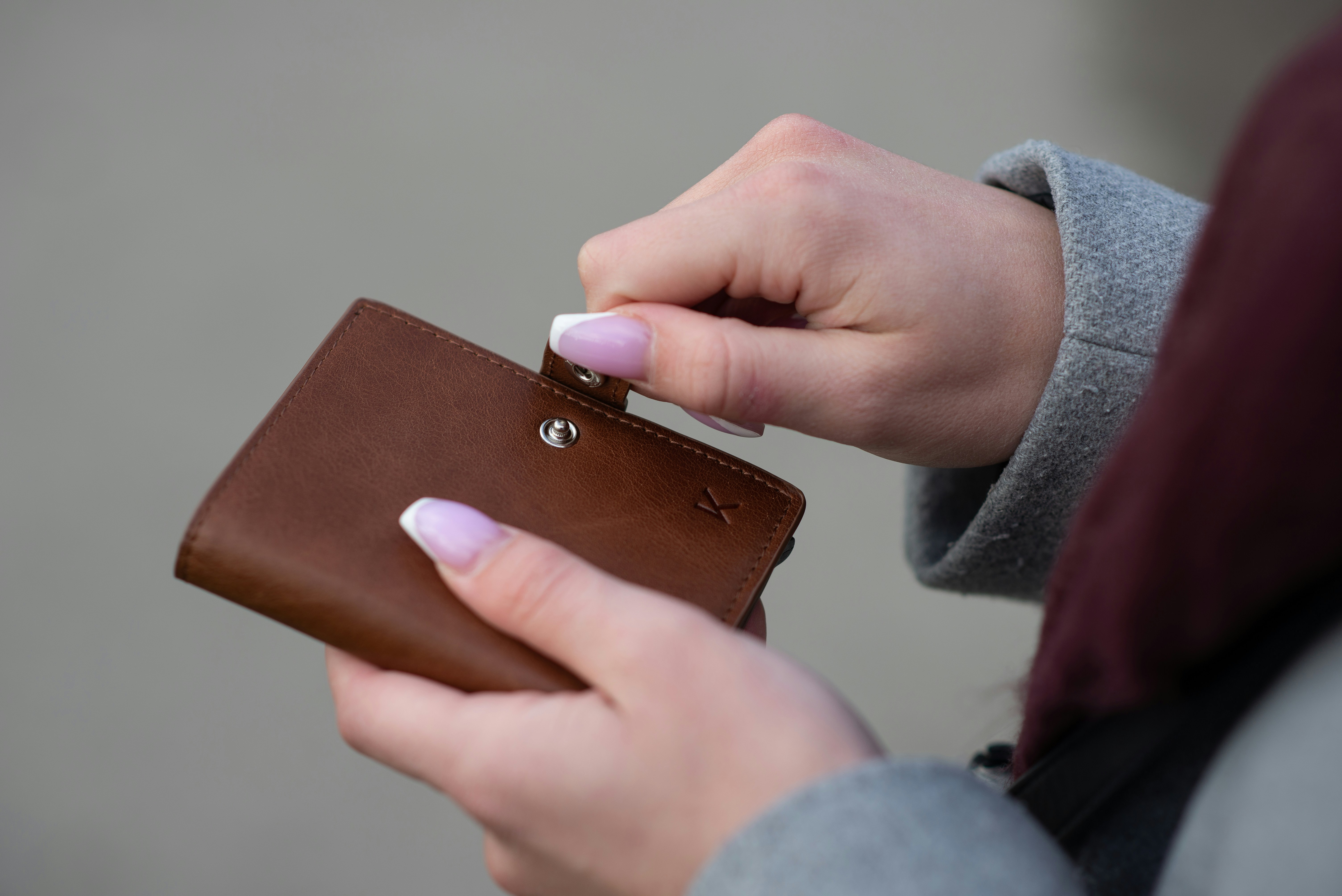 A woman holding her wallet | Source: Unsplash