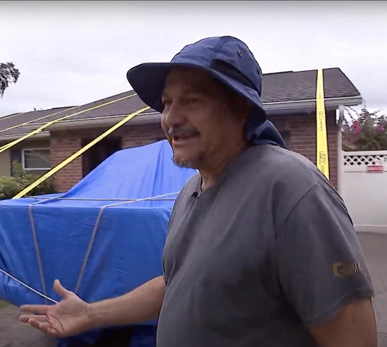 Pedro Caceres in front of his strapped-down home. | Source: YouTube/9NEWS