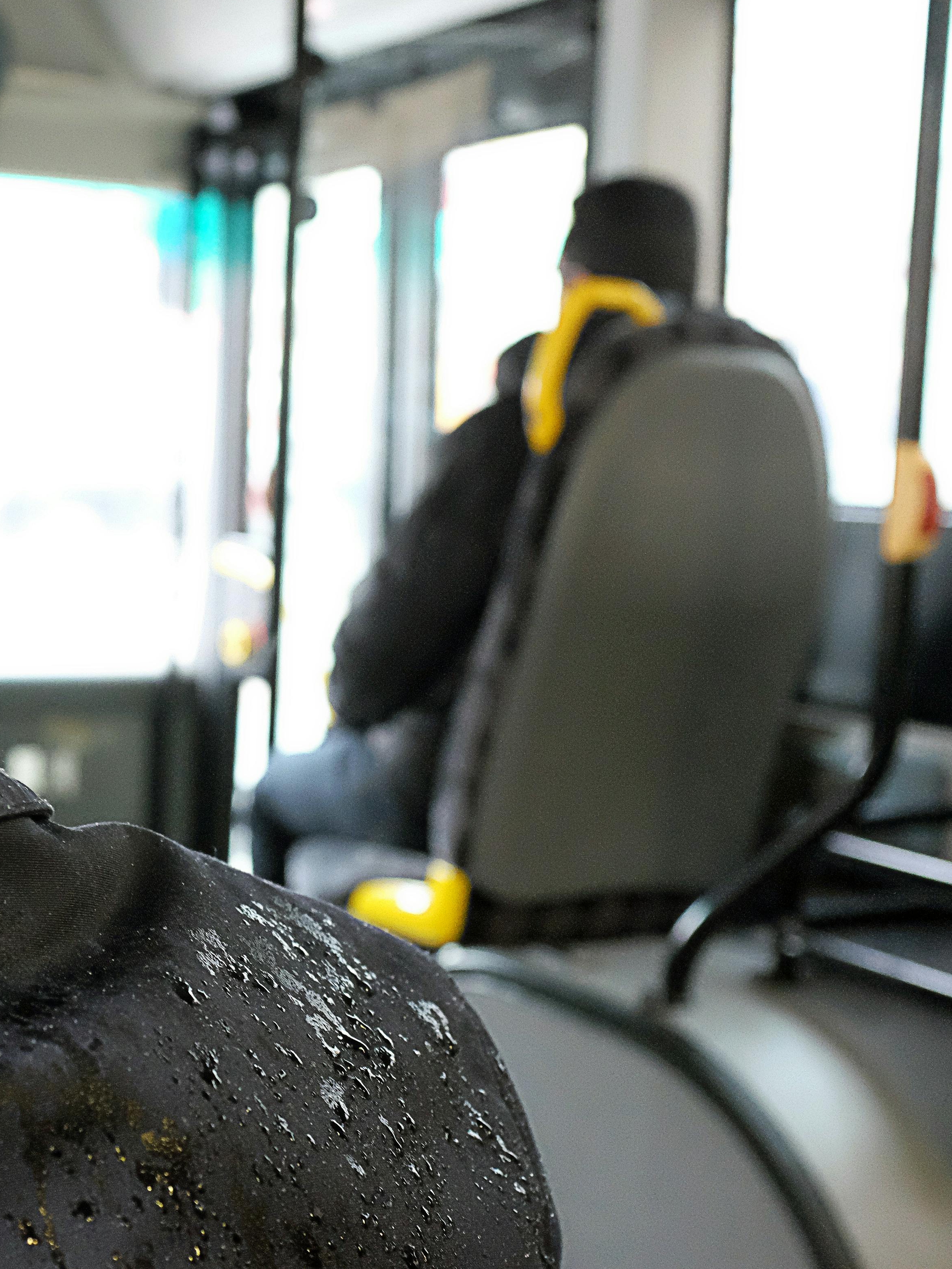 The man tries unsuccessfully to close the leaking roof hatch as rain starts dripping on him | Source: Pexels