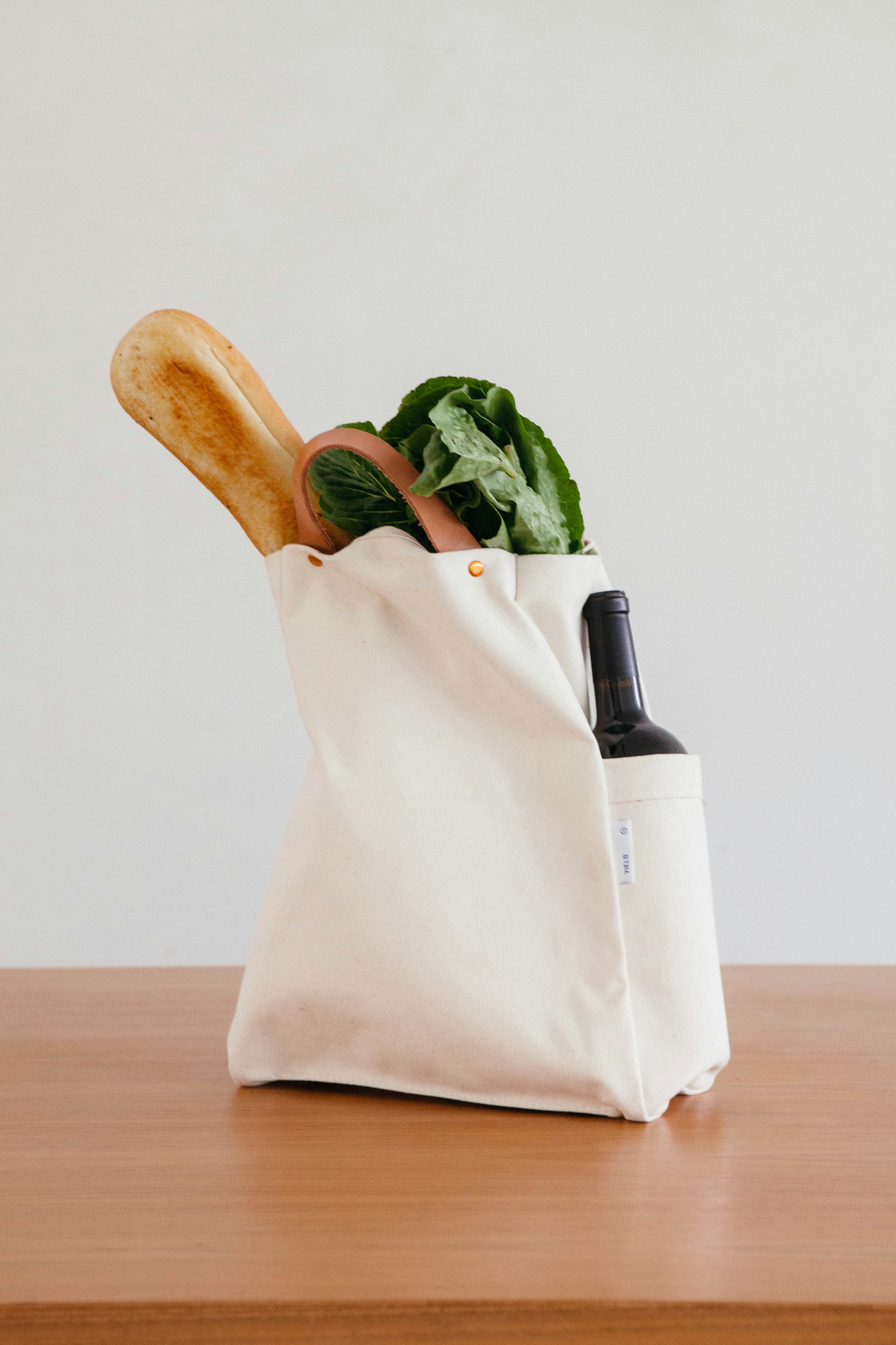 A bag of groceries and wine | Source: Unsplash