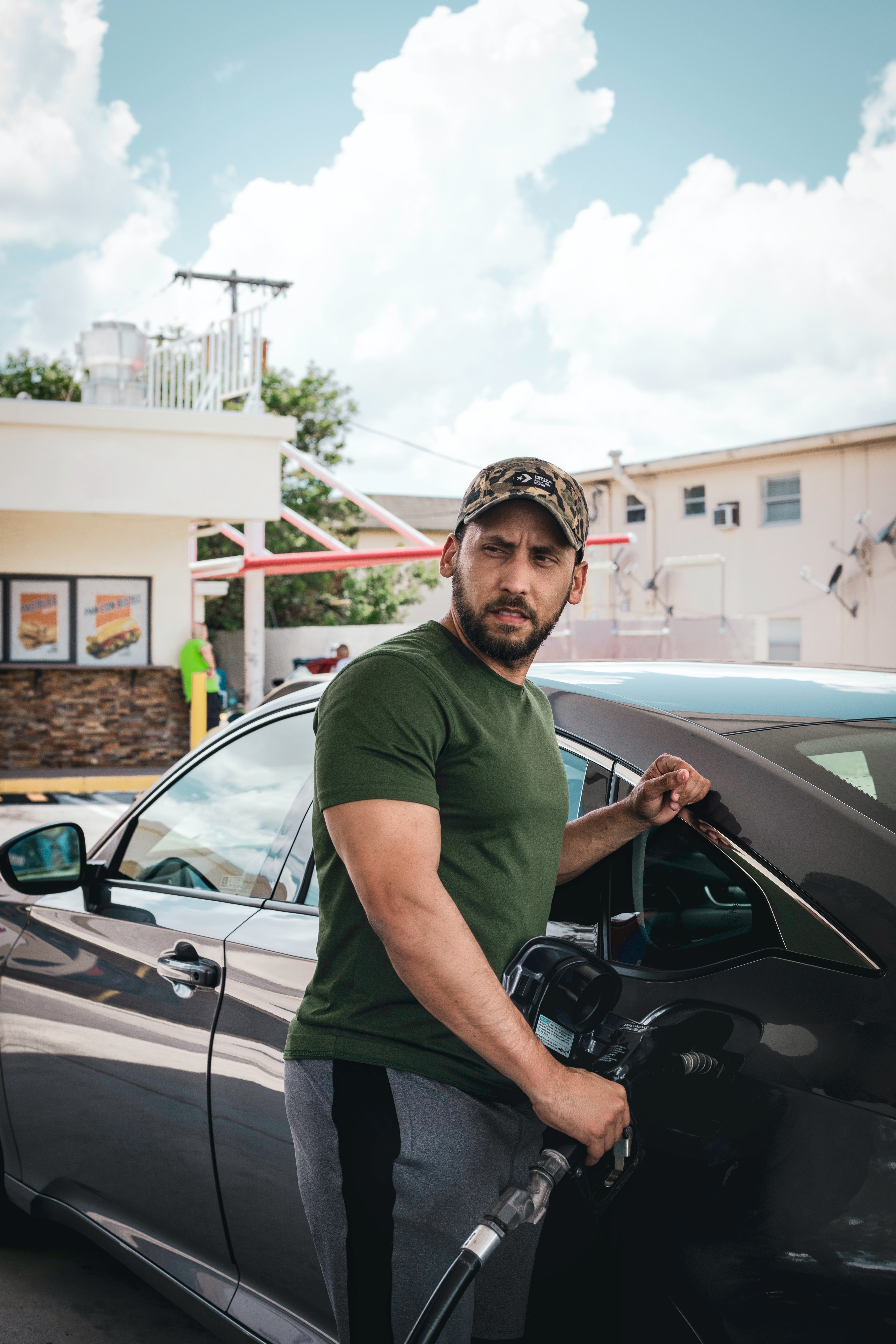 A man fills up his car with fuel at a gas station | Pexels/One Shot