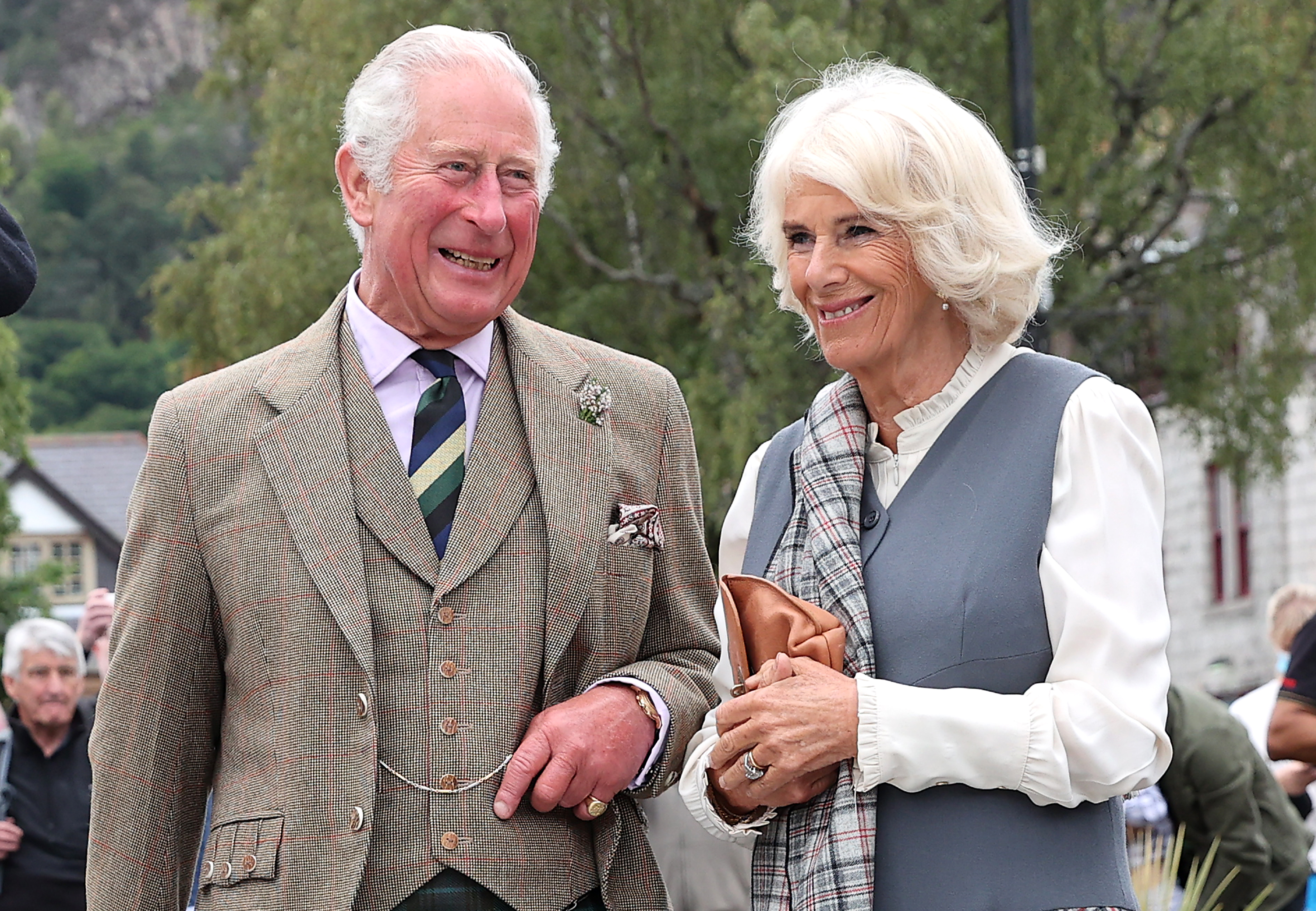 Prince Charles, Prince of Wales, and Camilla, Duchess of Cornwall, smile as they visit local shops and businesses during a short walk through the village in Ballater, Scotland, on August 31, 2021. | Source: Getty Images