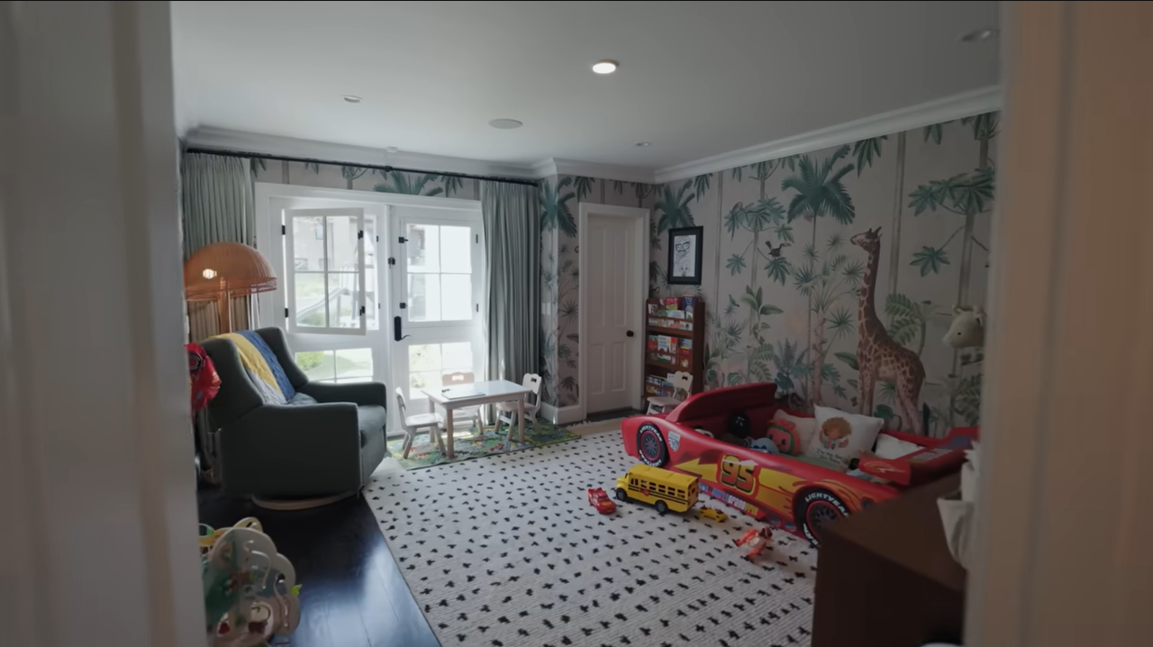 A wide look at Leo's jungle-themed room, fully equipped with a mini table and chairs for activities. | Source: YouTube/@Archdigest