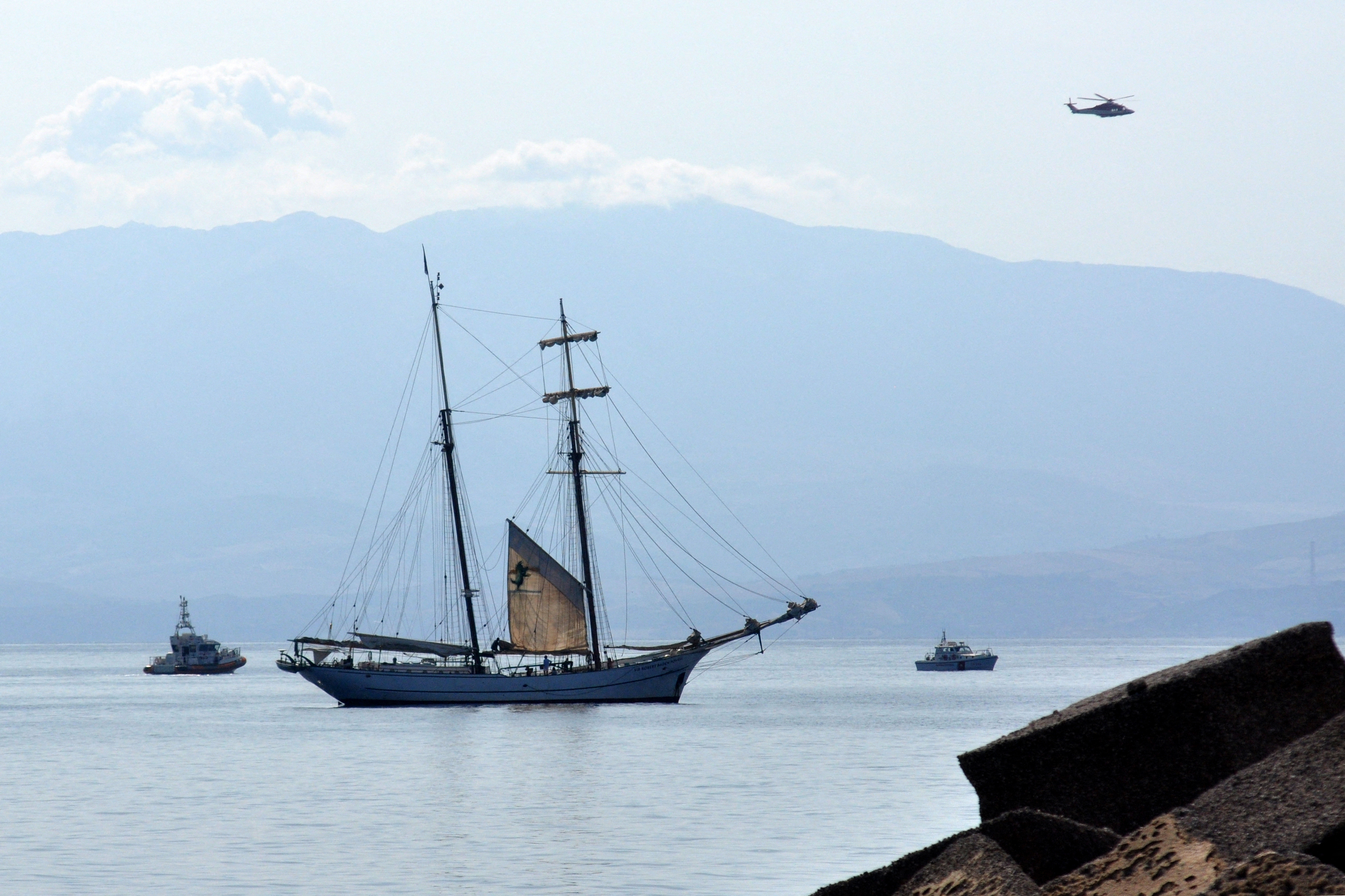 The Coast Guard, Italian fireboats, and a fire brigade helicopter search for missing passengers after the luxury yacht Bayesian sinks off Porticello, Sicily | Source: Getty Images