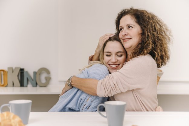 Mother hugging daughter | Source: Freepik