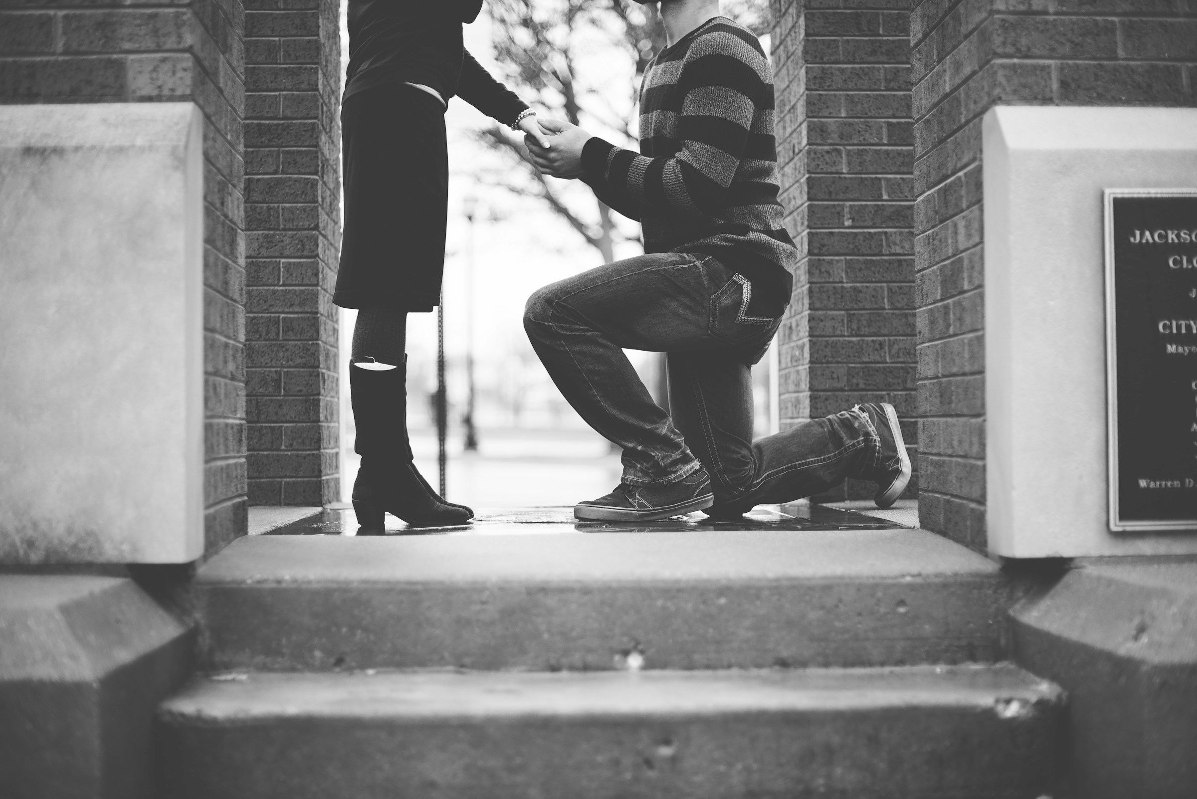 Grayscale shot of a man proposing to a woman | Source: Unsplash