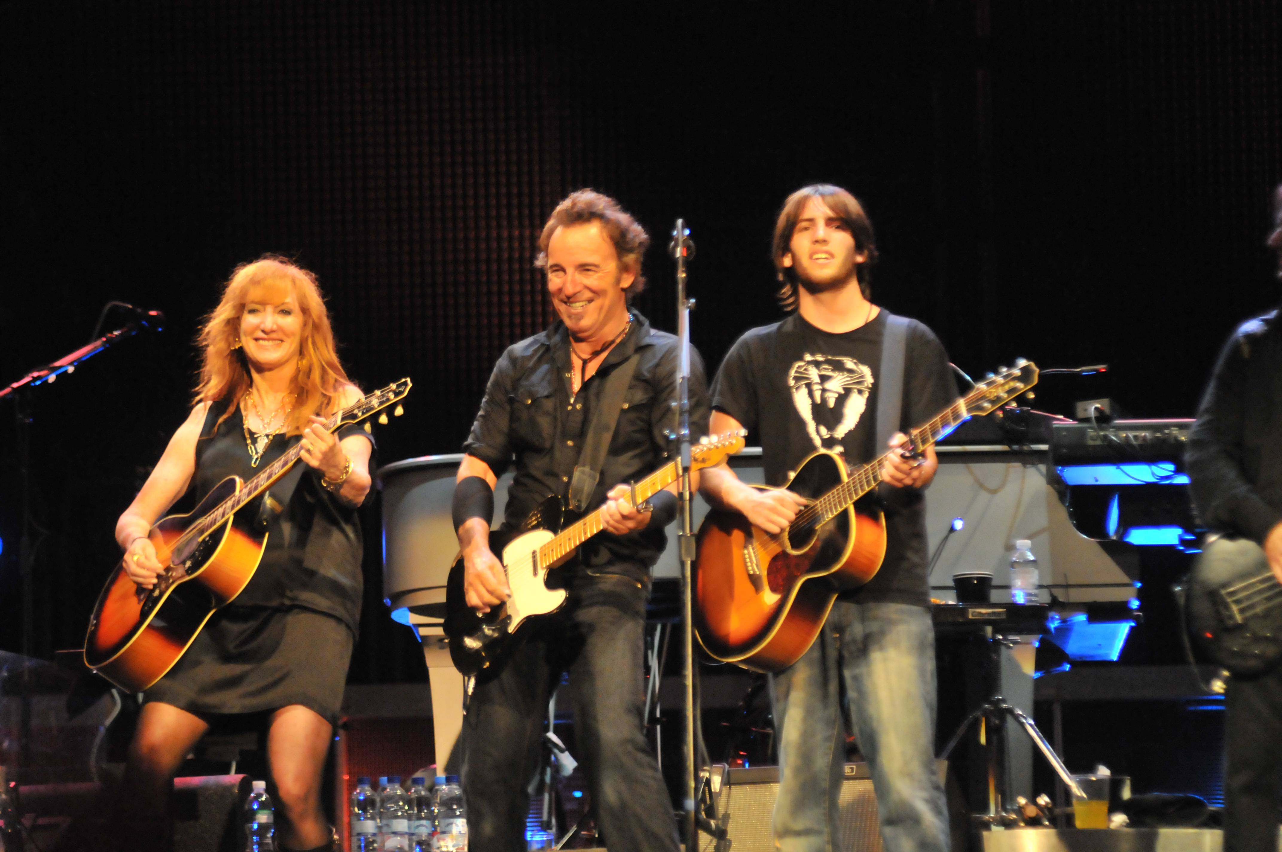 Patti Scialfa, Bruce Springsteen and their son Evan Springsteen performing live onstage in Spain. | Source: Getty Images