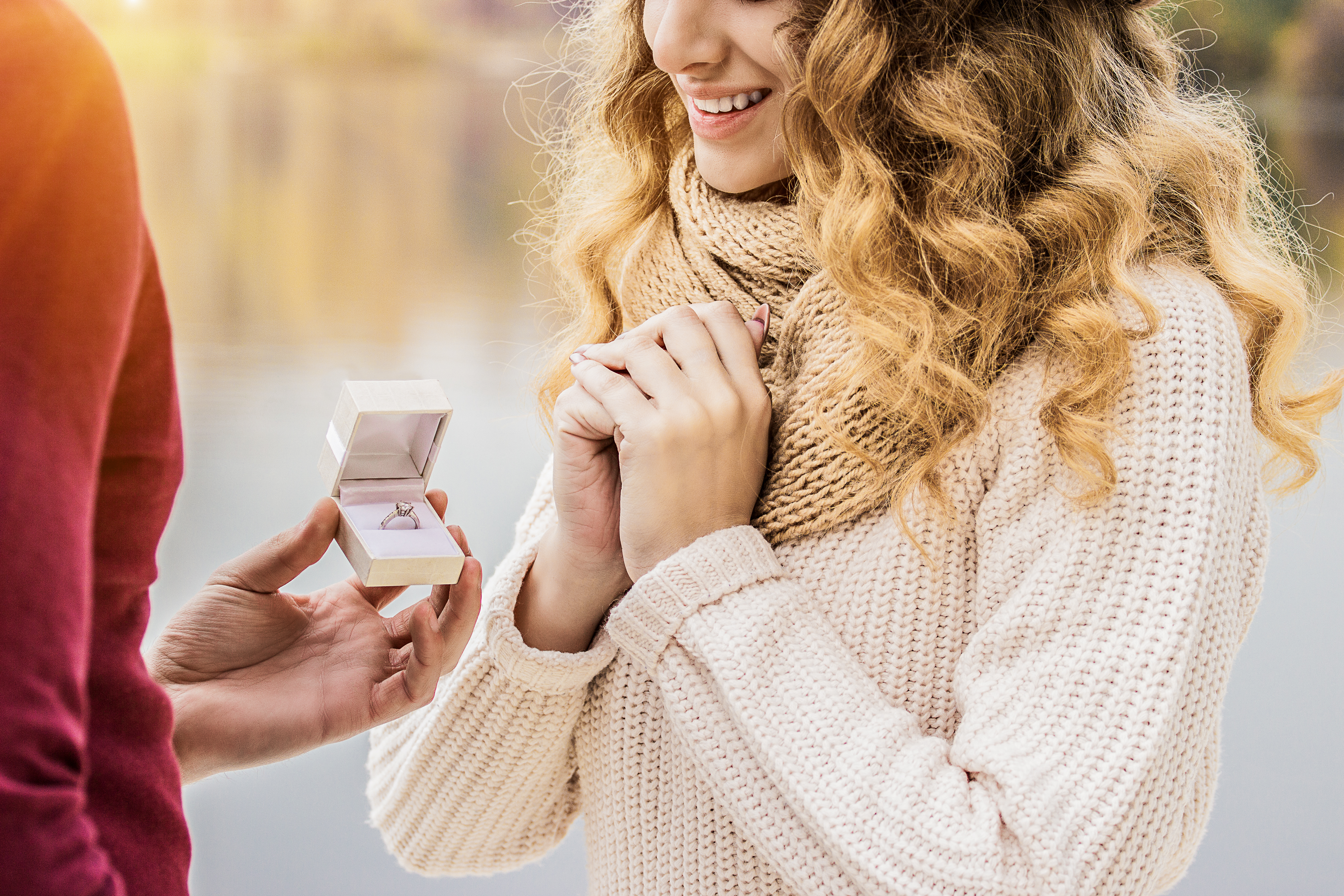 A cropped image of a young man proposing to his girlfriend | Source: Shutterstock