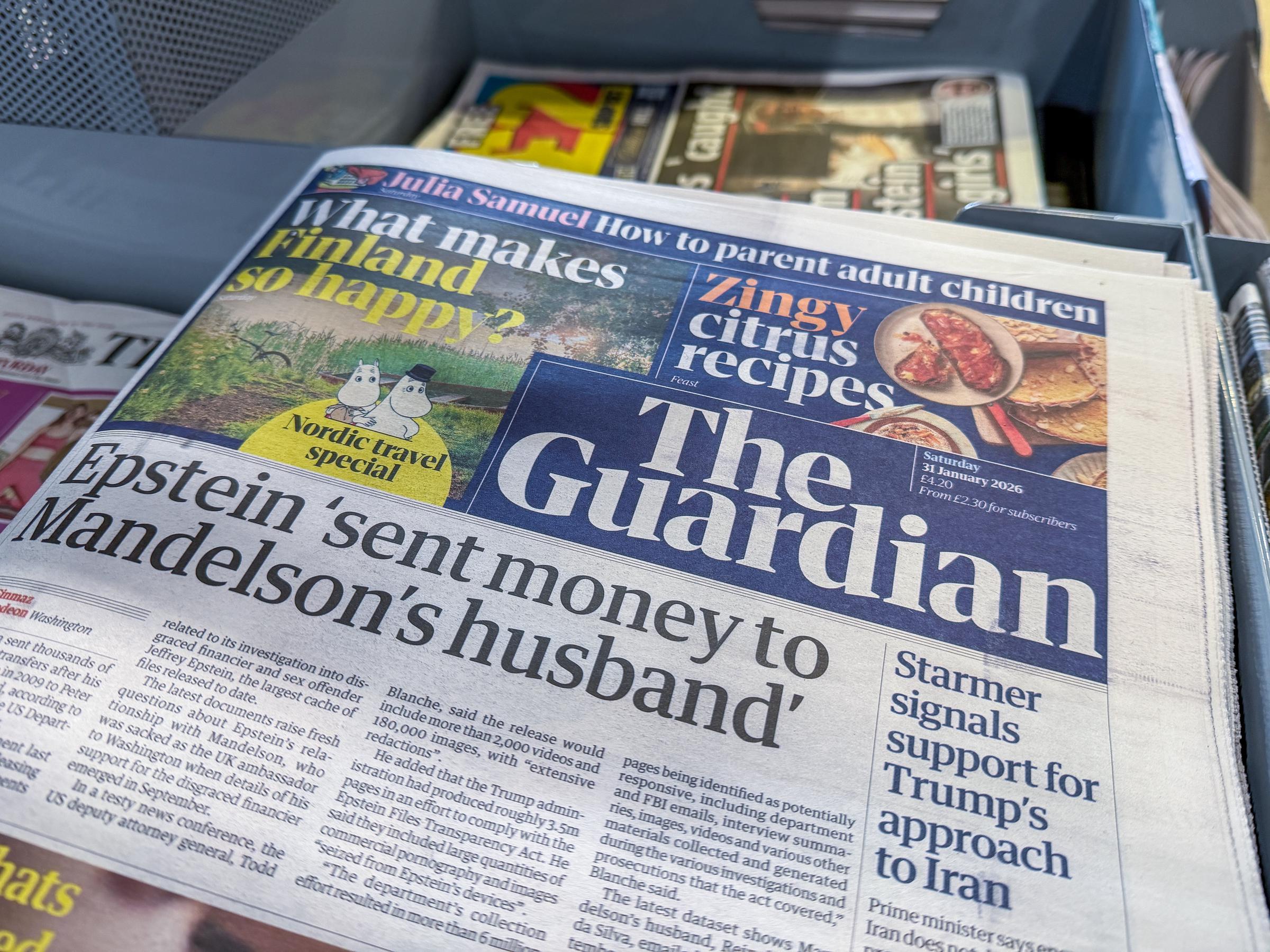 A UK newspaper front pages including The Guardian display stories on the latest Jeffrey Epstein files release in a newsagent's shop, on January 31, 2026, in Somerset, England. | Source: Getty Images