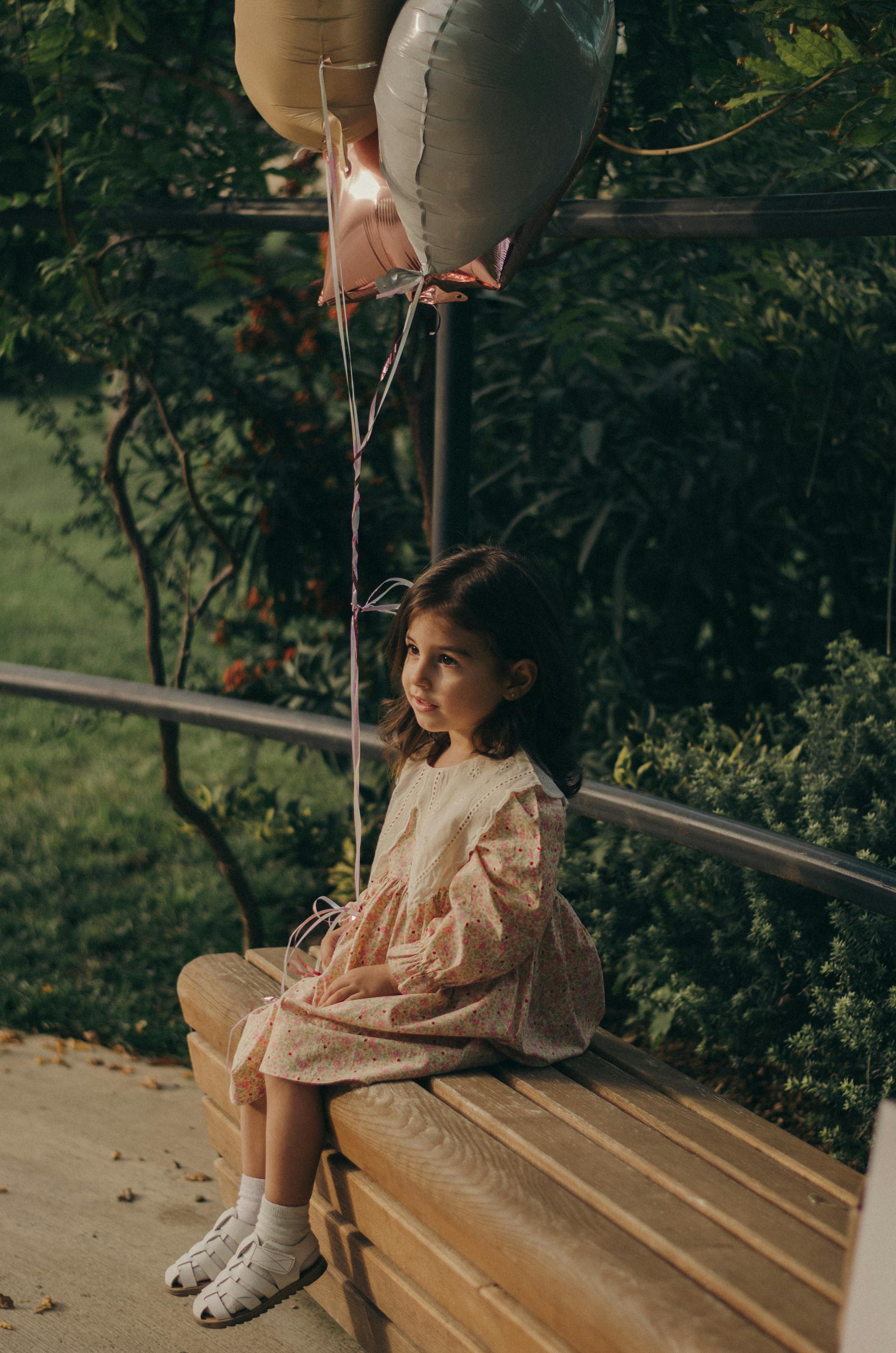 A little girl sitting on a park bench | Source: Pexels