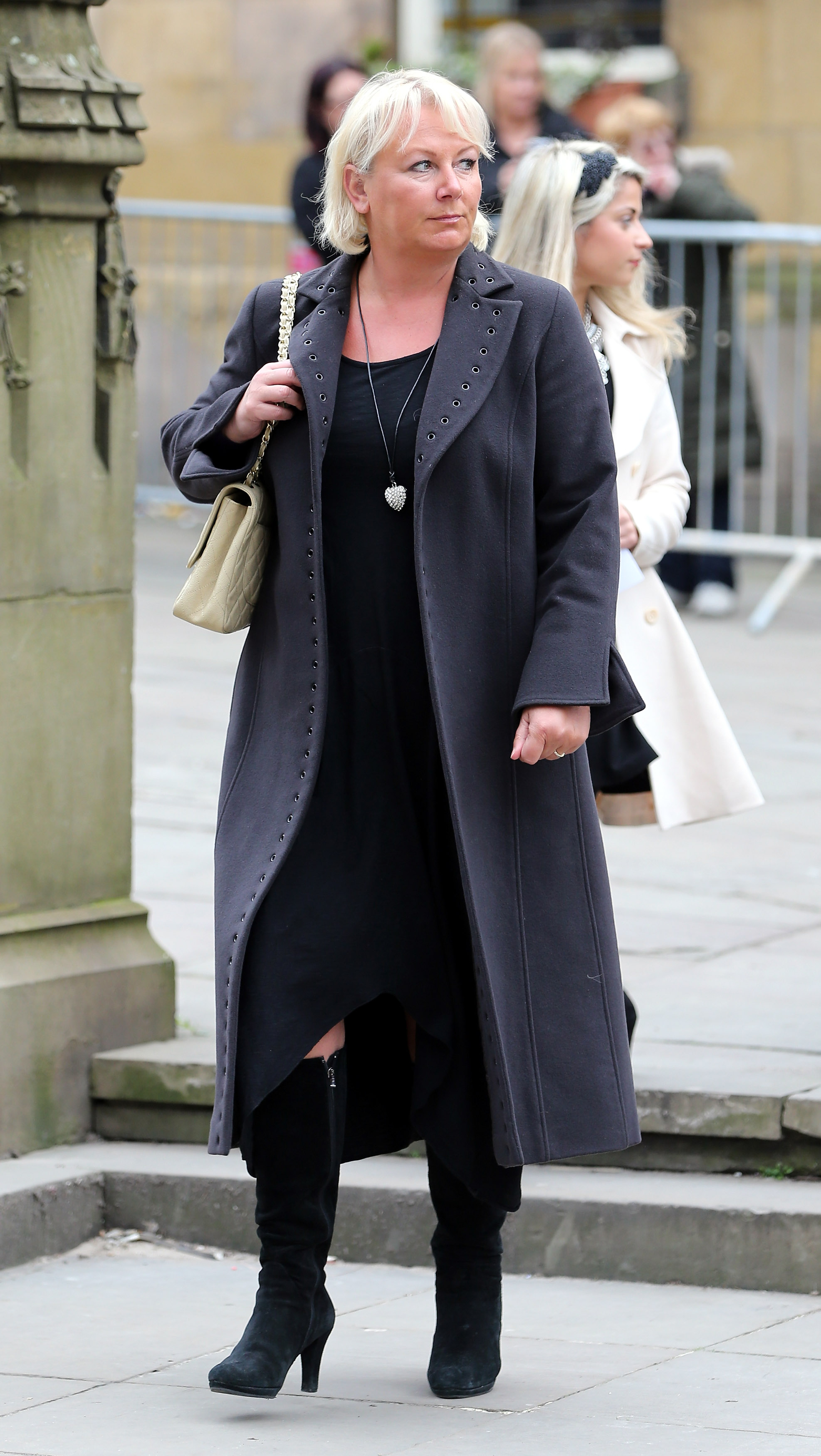 Cleaver cuts a sombre figure in a long charcoal coat, knee-high black boots and a heart-shaped pendant necklace as she arrives at Manchester Cathedral for the funeral of "Coronation Street" creator Tony Warren — the same year she would quietly begin reassessing her health and eating habits.