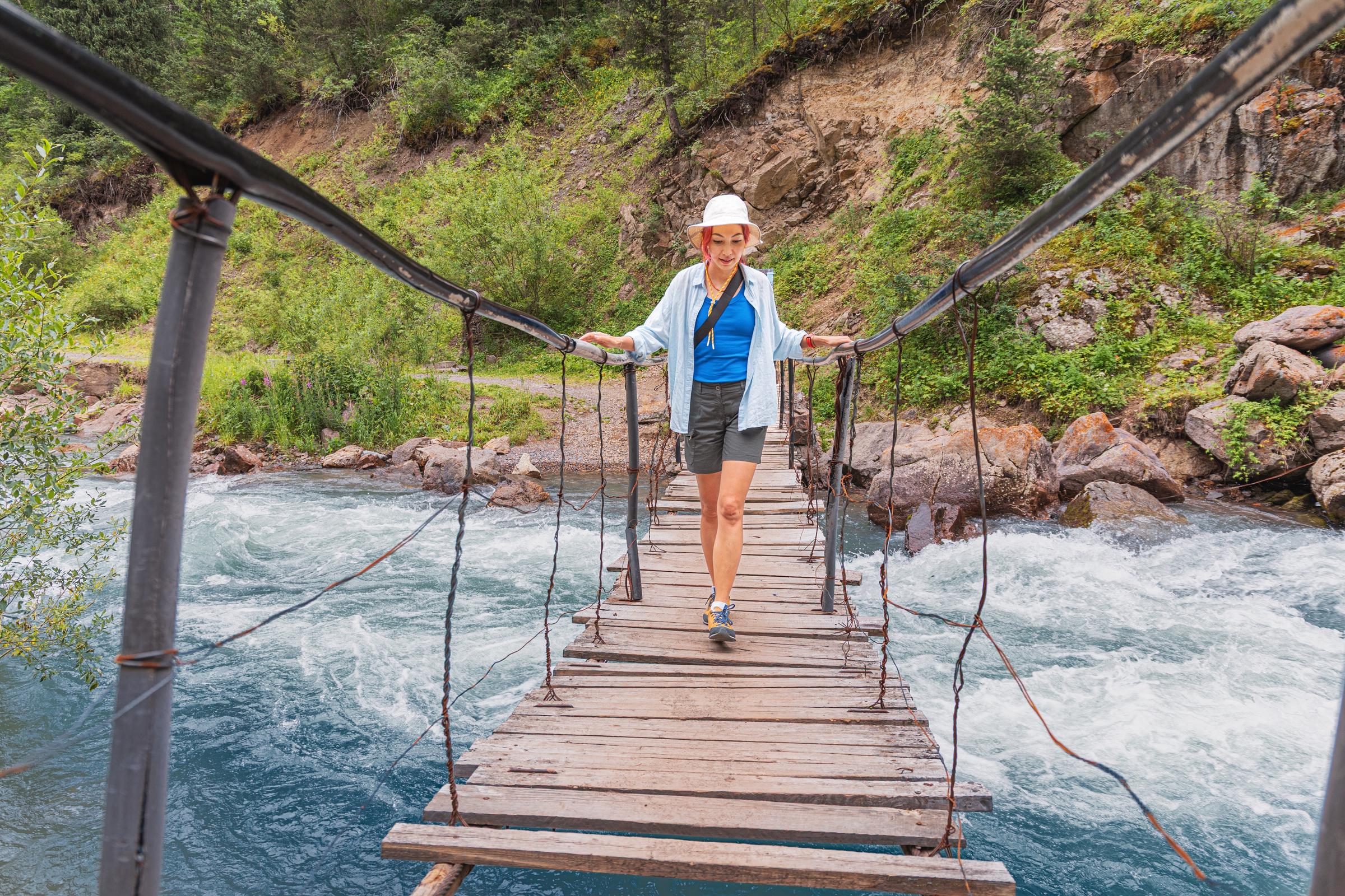 A woman bravely crossing a bridge | Source: Shutterstock