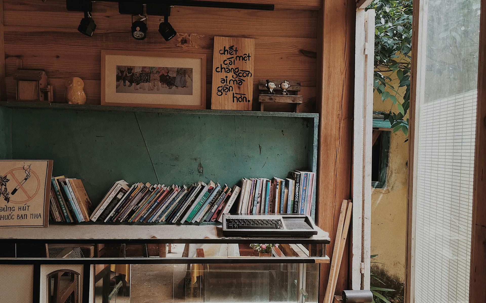 Books placed in a wooden rack on the wall | Source: Pexels