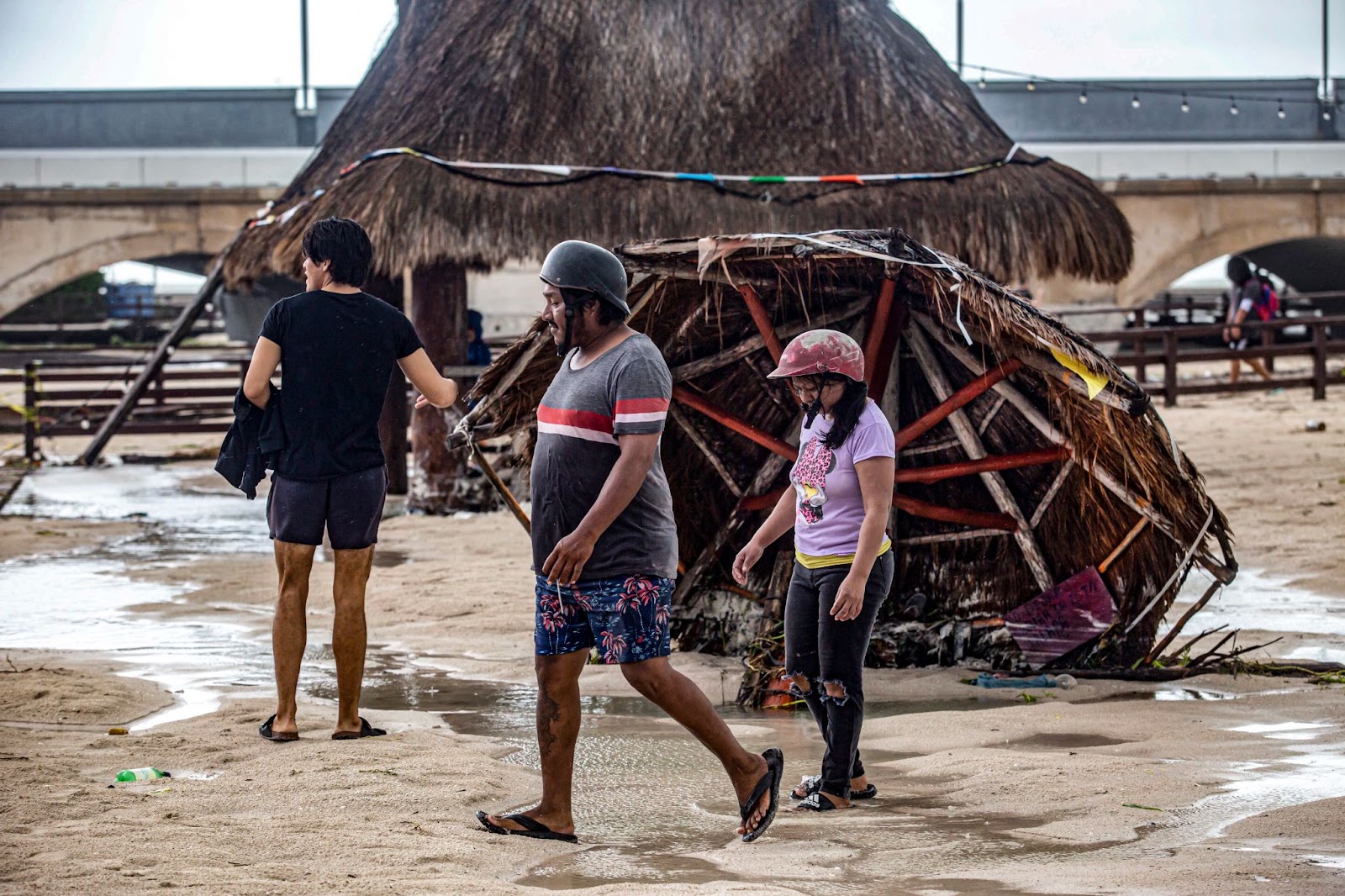 Residents walk along structures damaged by Hurricane Milton on the coast of Puerto Progreso, Yucatán State, Mexico, on October 8, 2024. | Source: Getty Images