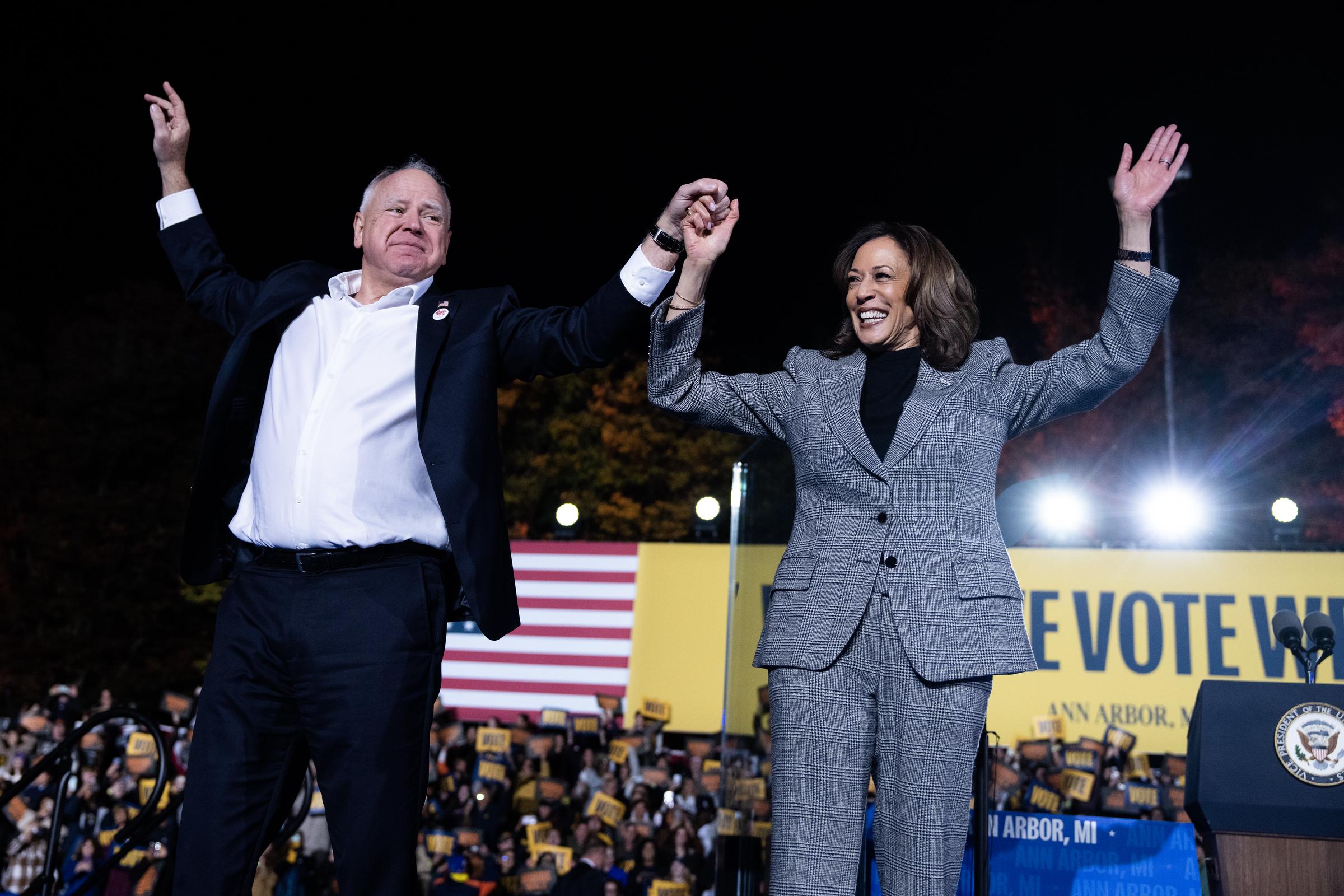 Kamala Harris and Tim Walz, wave to the crowd during a rally at Burns Park in Ann Arbor on October 28, 2024 | Source: Getty Images