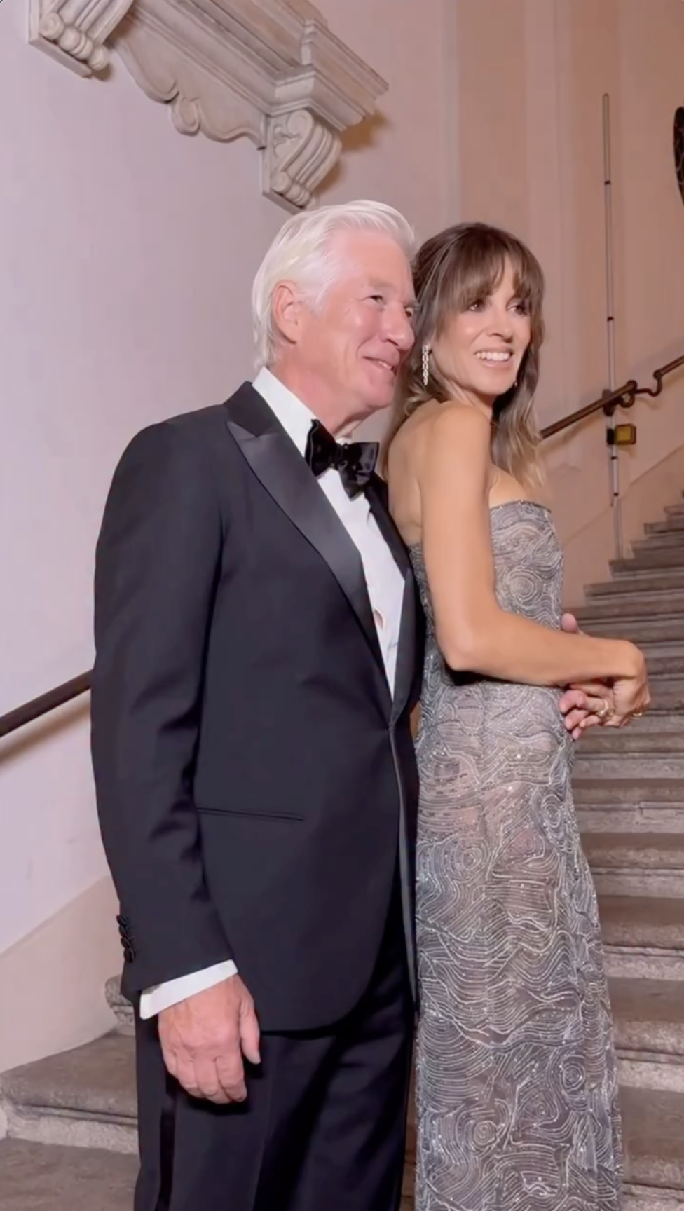 Alejandra Silva flashes a radiant smile beside Richard Gere as the cameras capture their warm chemistry and flawless style inside the Armani tribute venue. | Source: Instagram/voguemagazine