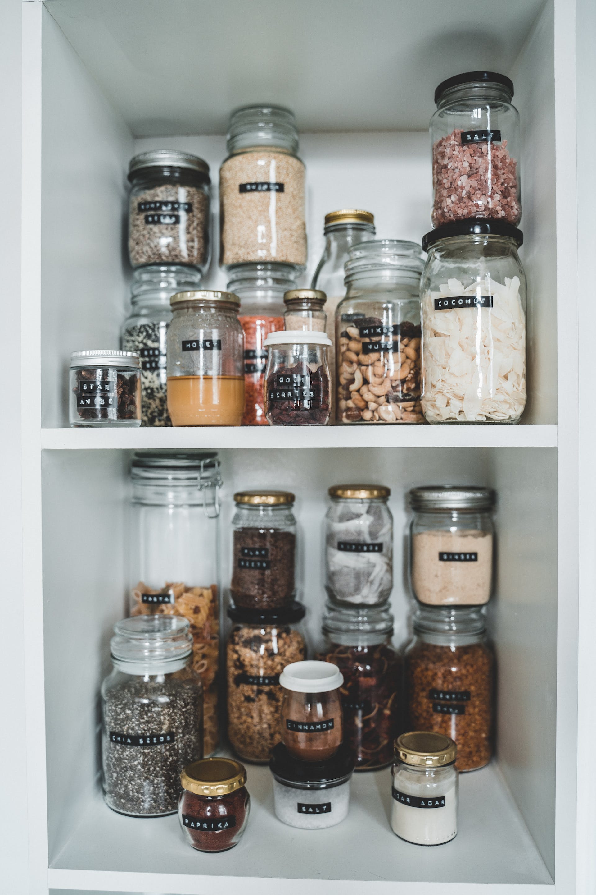 Clear mason jars in a cabinet | Source: Pexels