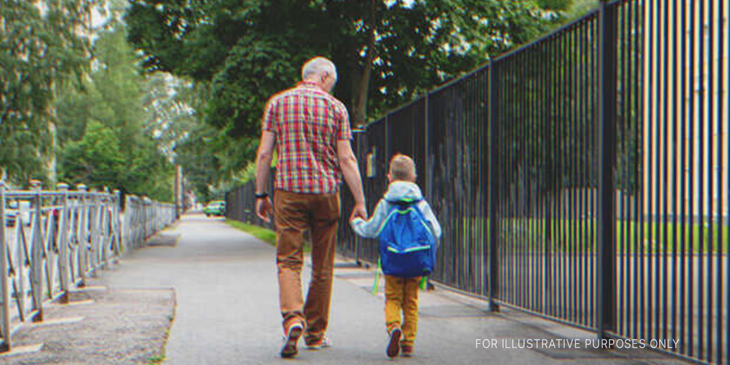 Man and Boy Holding Hands While Walking. | Source: Shutterstock