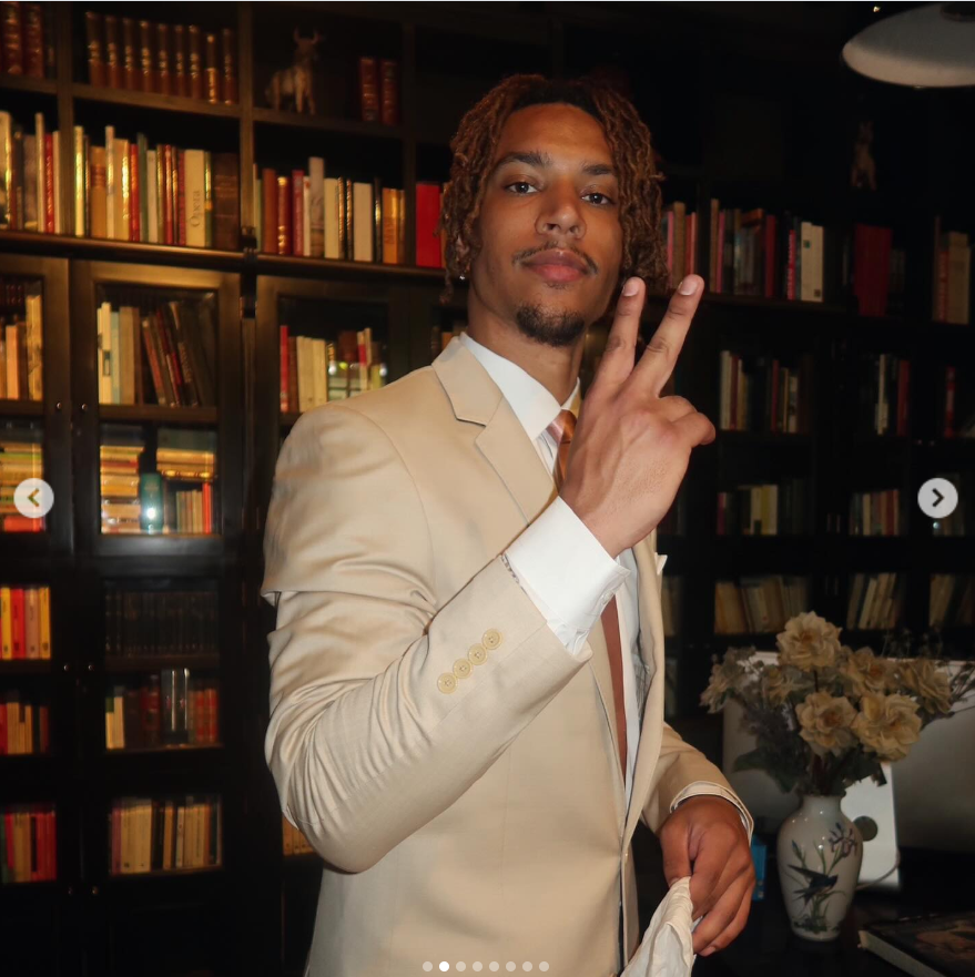 Brandon Clarke poses in a cream-colored suit while flashing a peace sign. | Source: Instagram/brandon_clarke23