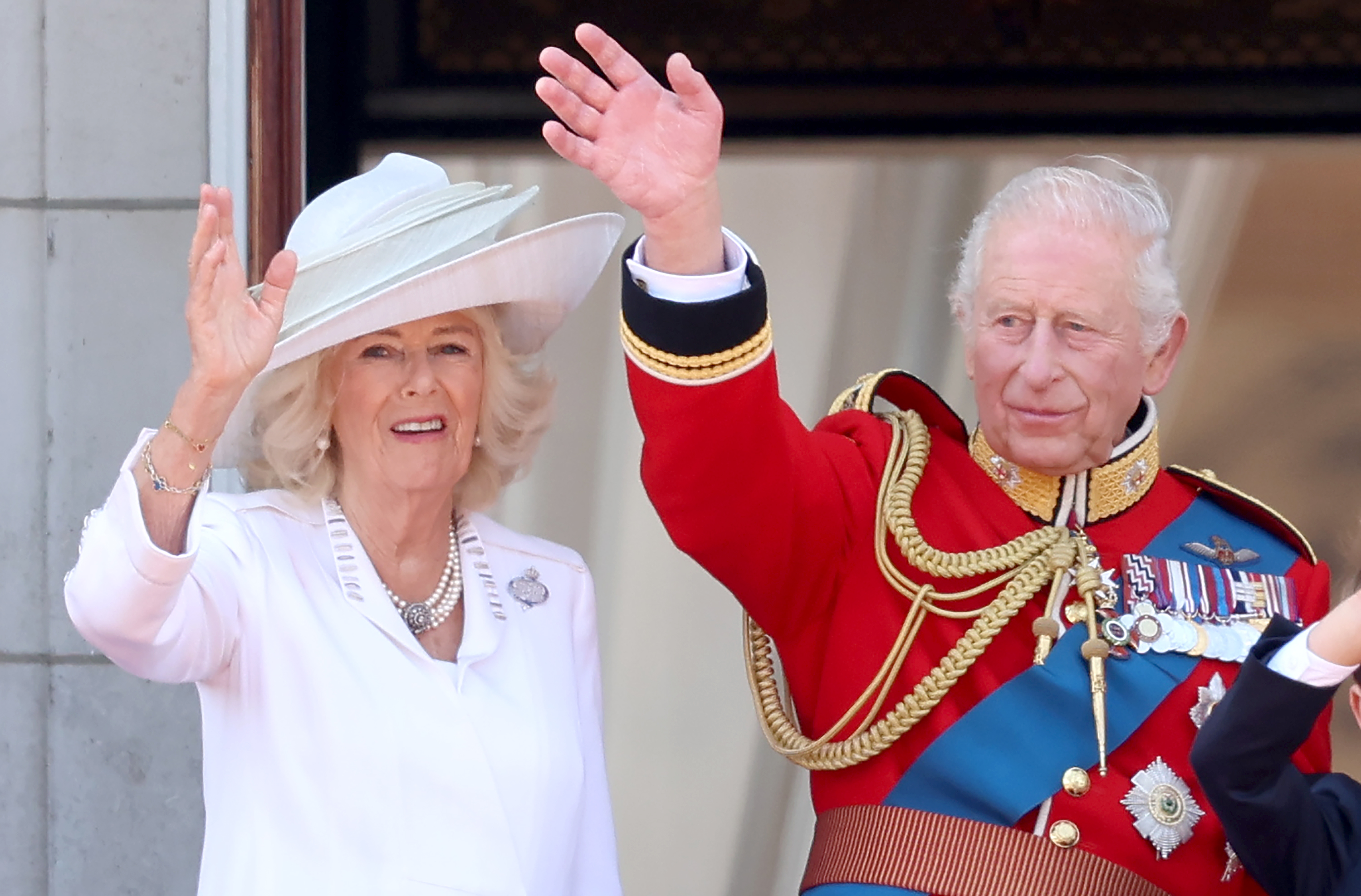 Queen Camilla and King Charles III waving at onlookers. | Source: Getty Images