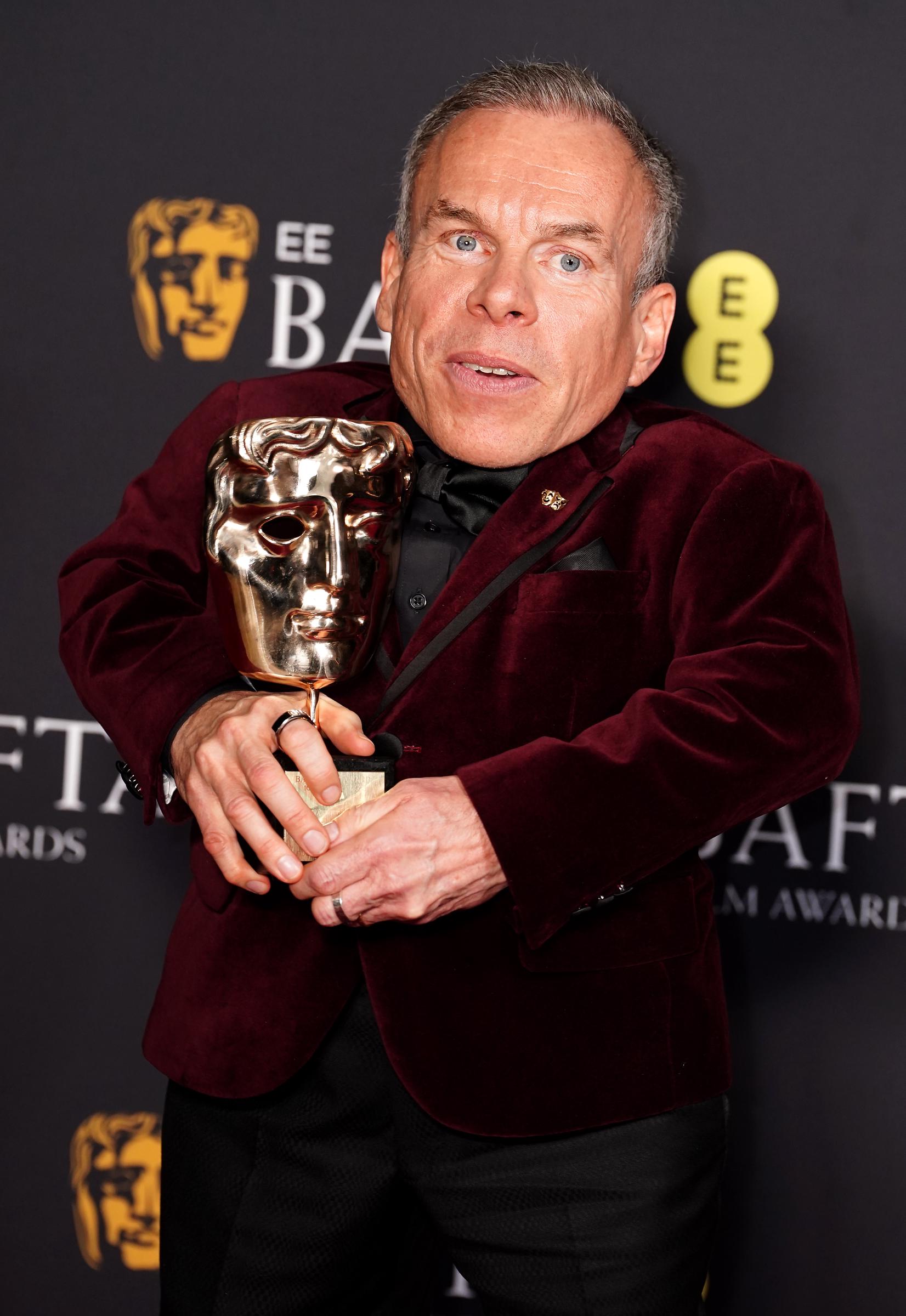 Warwick Davis in the press room after winning the BAFTA Fellowship Award during the 78th British Academy Film Awards on February 16, 2025 | Source: Getty Images