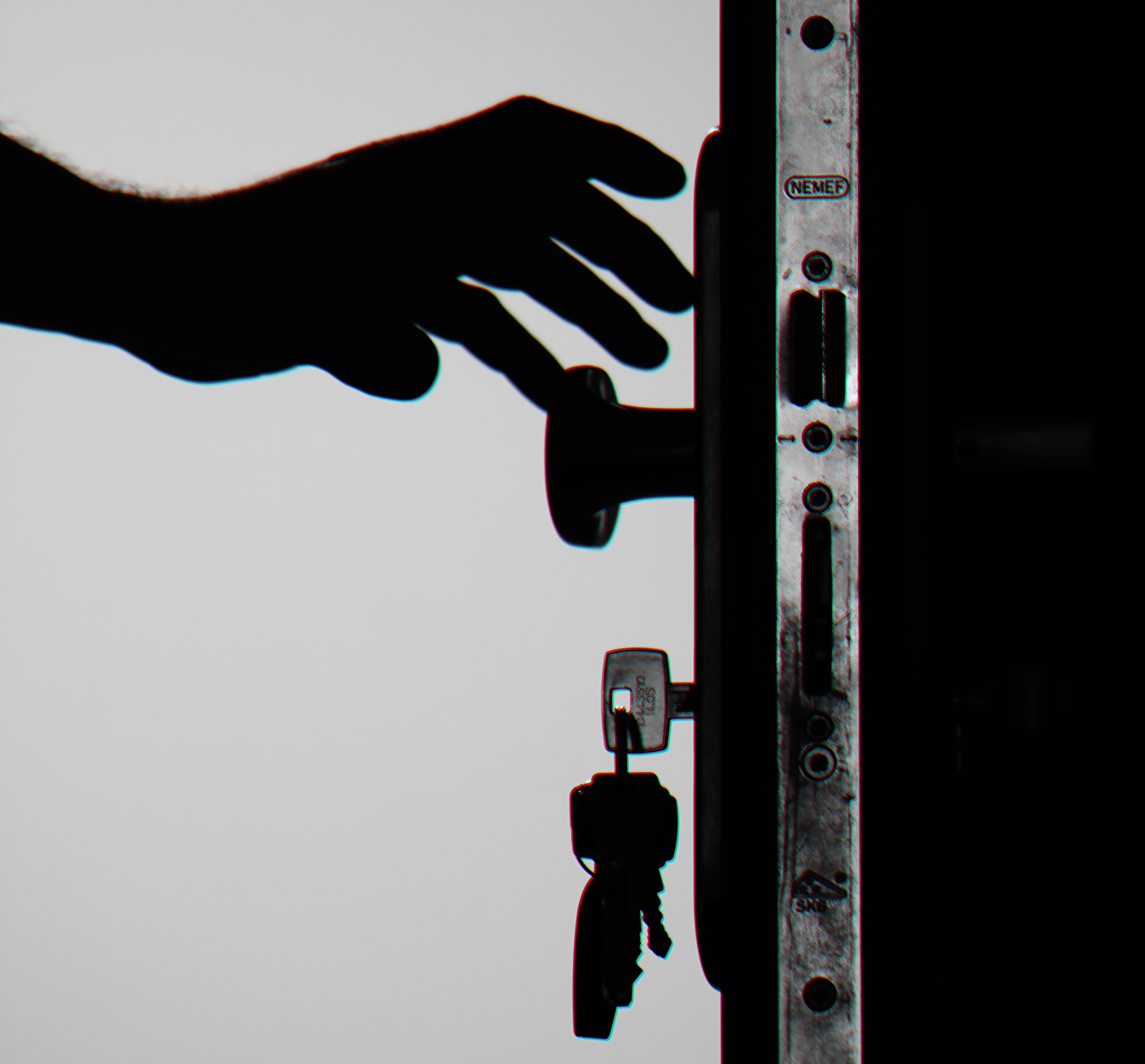Silueta de una mano abriendo una puerta con unas llaves. | Foto: Pexels