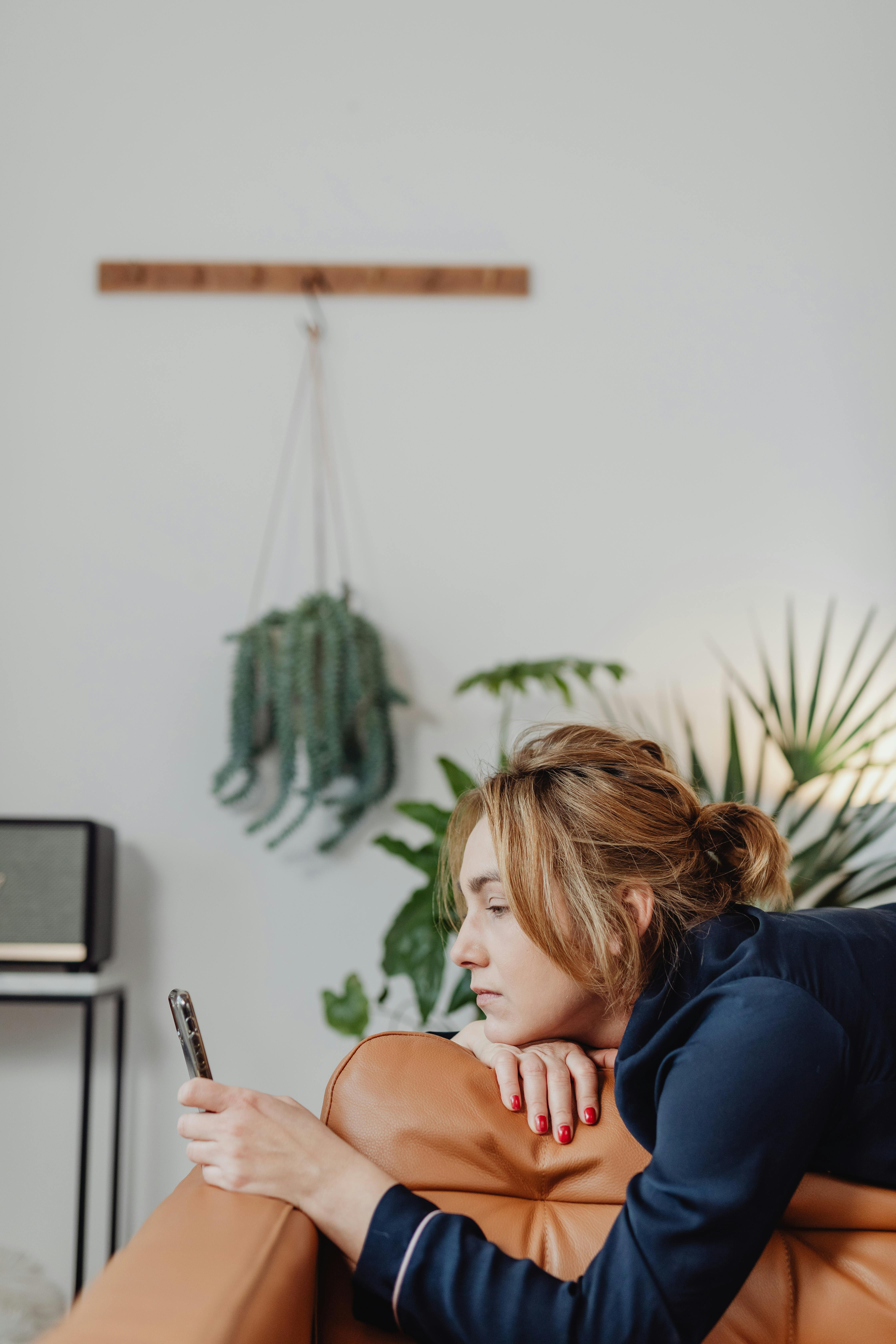 A sad woman looking at her phone | Source: Pexels