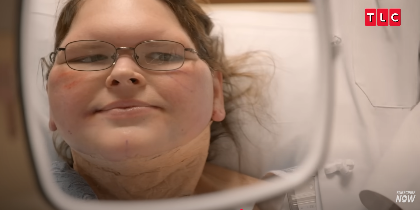 Tammy holds up the mirror to see her face, from a video posted on June 11, 2025 | Source: YouTube/AccessHollywood