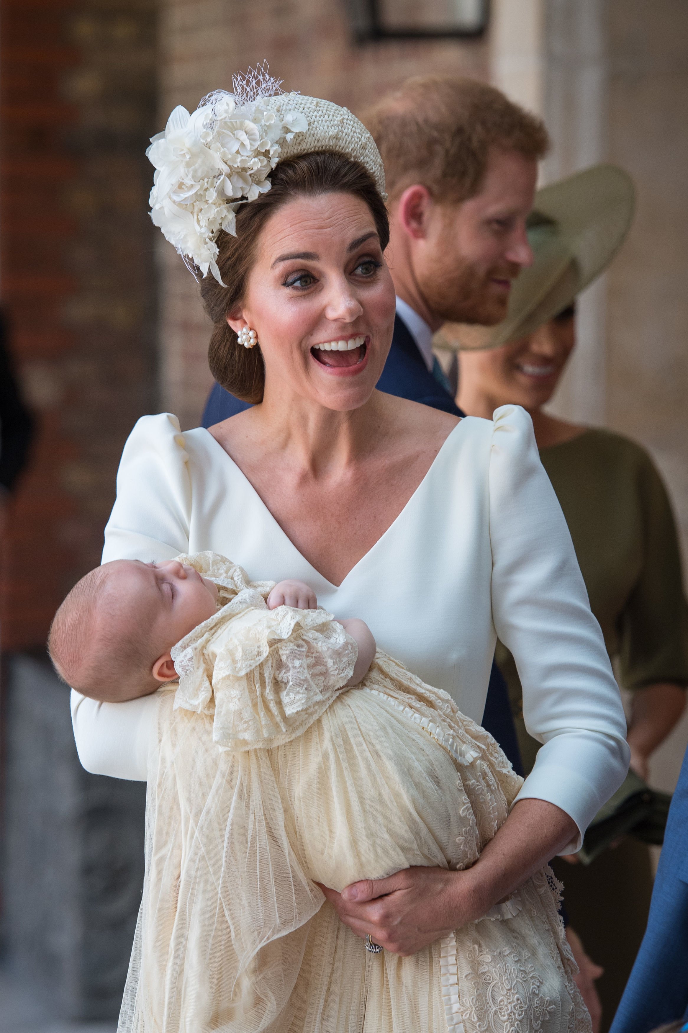 Prince Louis wearing the replica of the royal christening gown while being held by Kate Middleton at St James's Palace in London, England | Photo: Getty Images