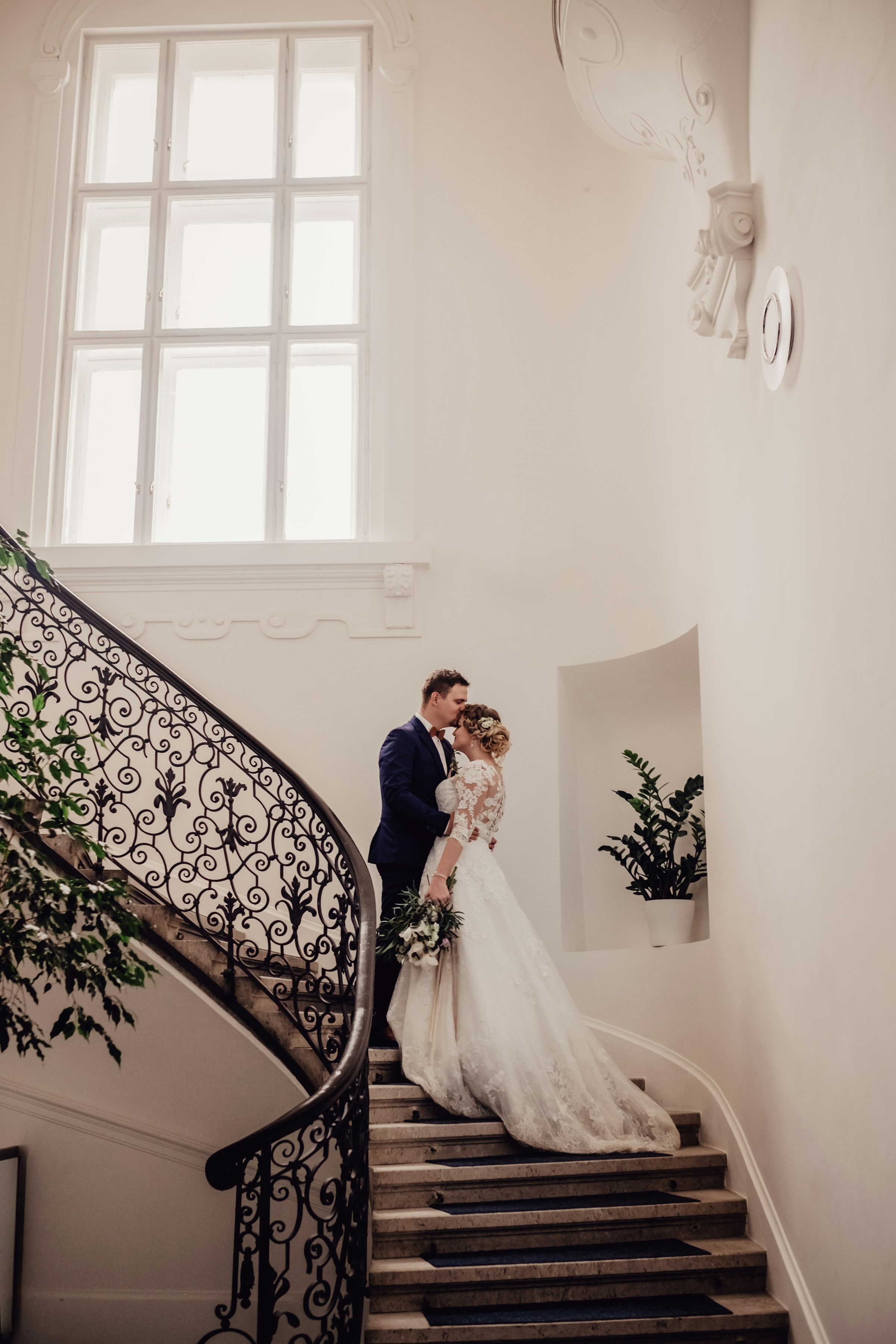 A bridal couple on a staircase | Source: Unsplash