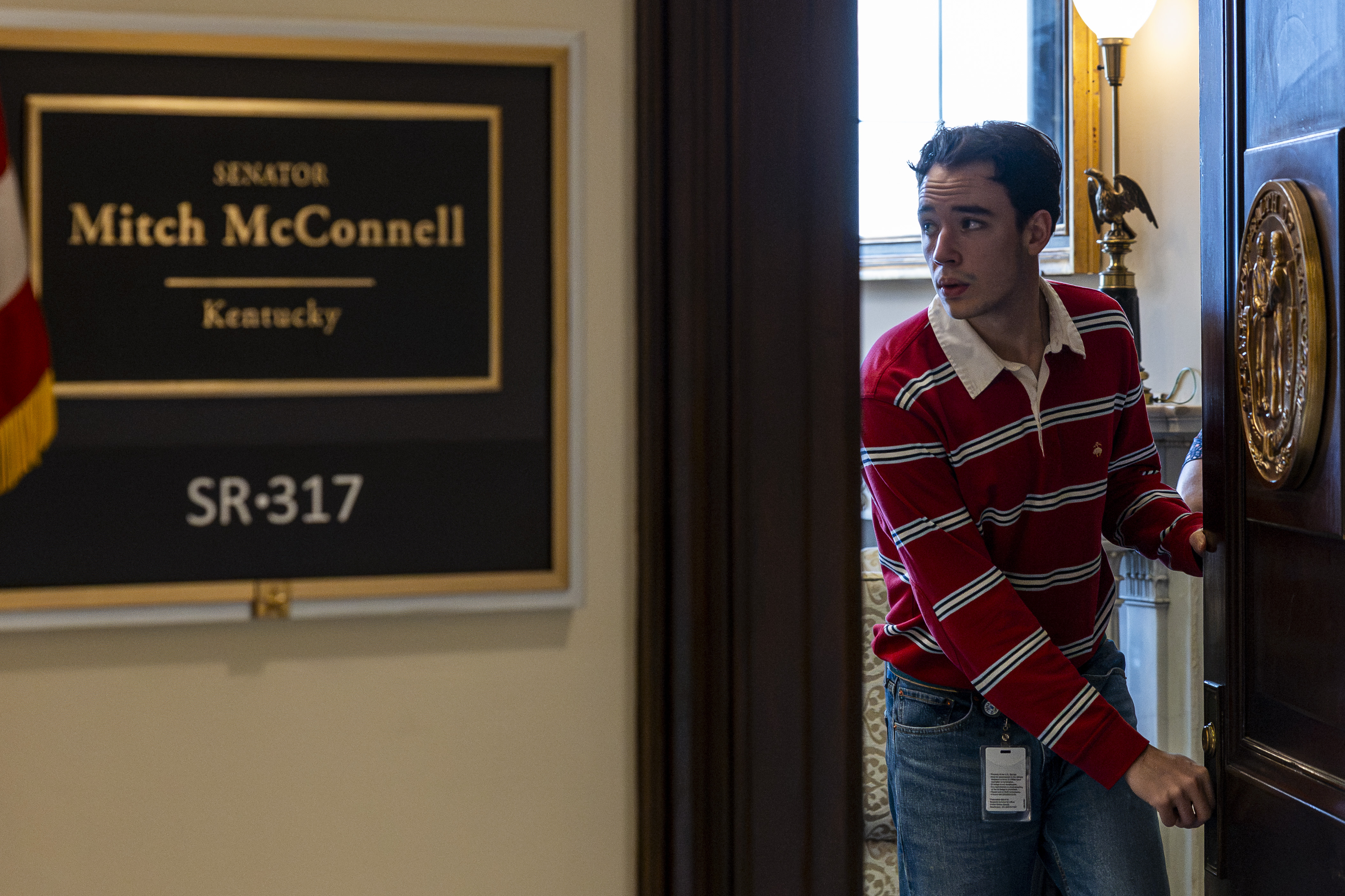 A staff member closes the door to Mitch McConnell's Senate office on July 8, 2026. His extended absence from the Senate fueled growing public interest before he eventually explained what had happened. | Source: Getty Images