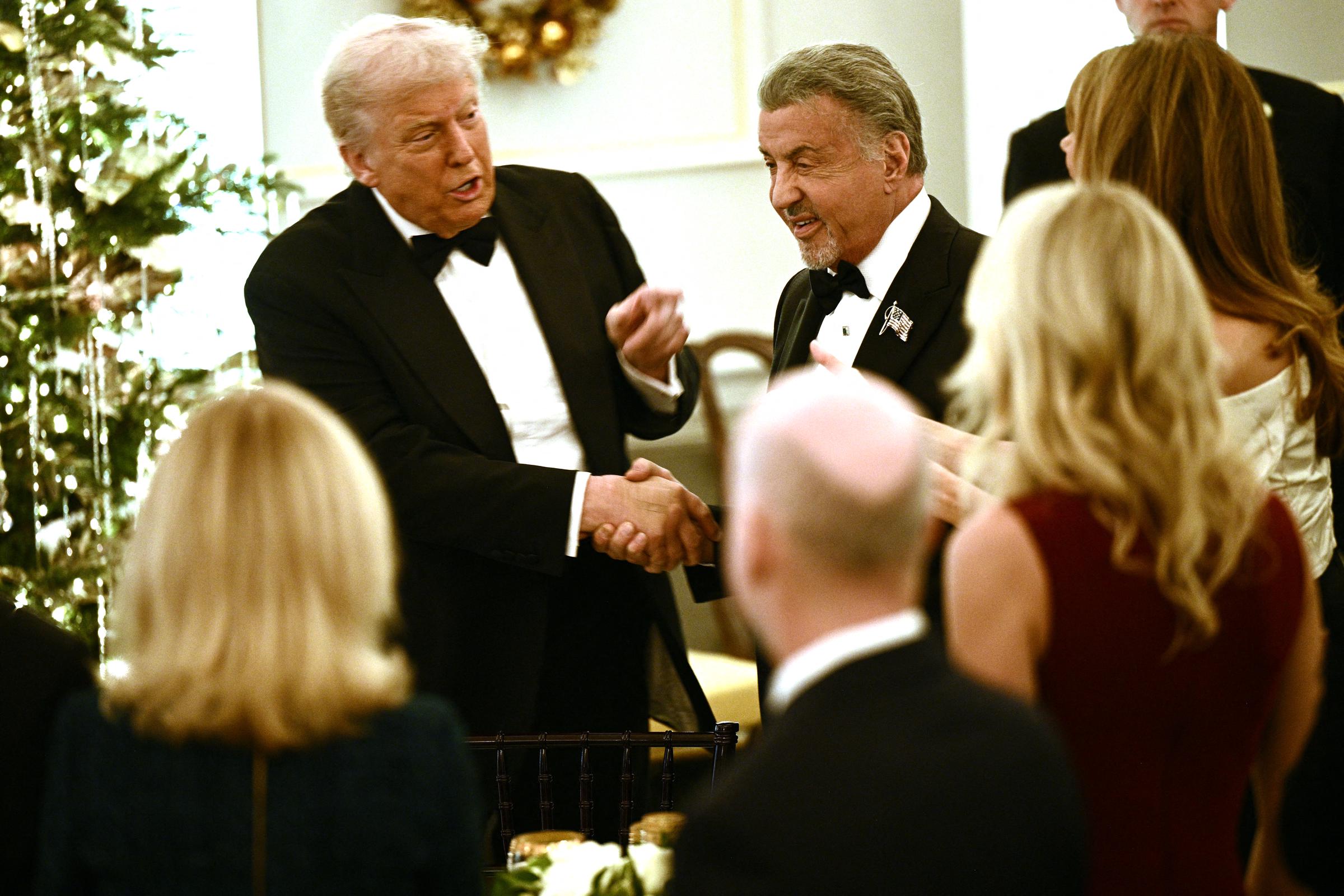 US actor Sylvester Stallone shakes hands with US President Donald Trump during the Kennedy Center Honors dinner