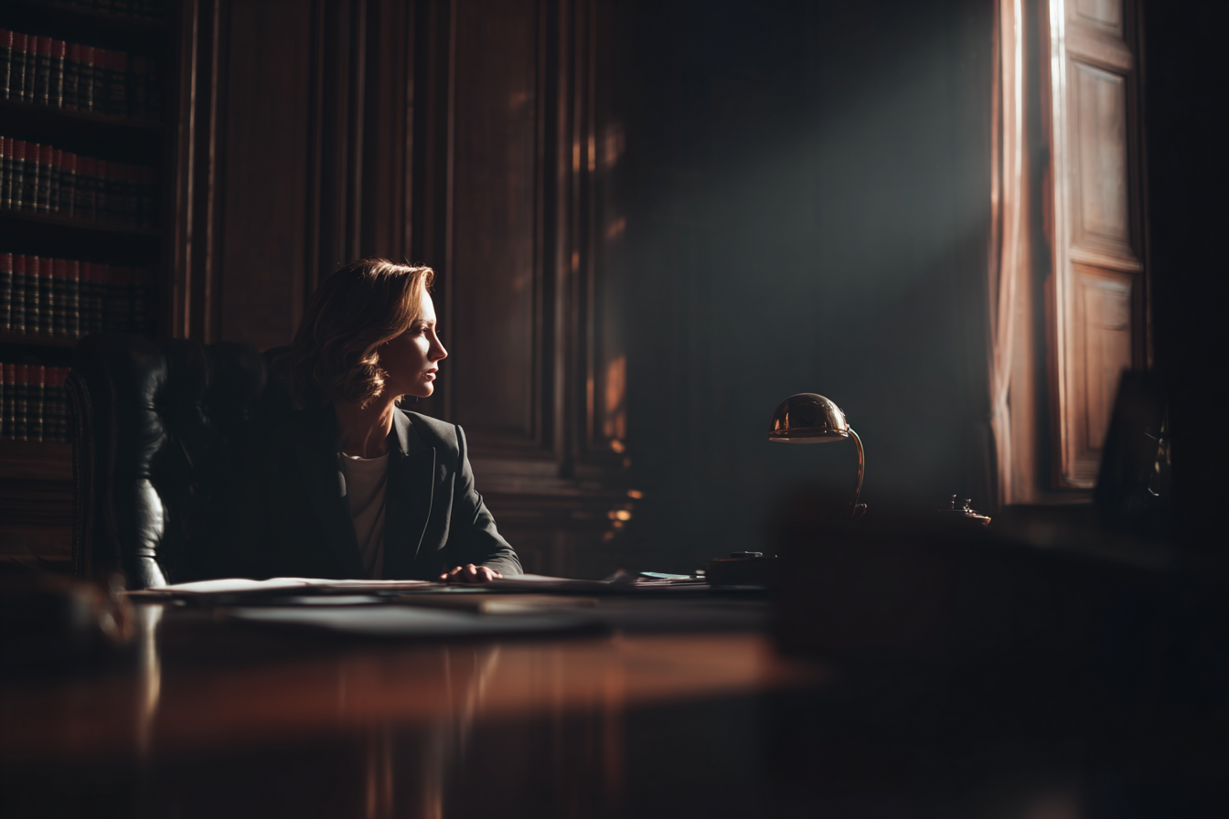 A lawyer sitting in her office | Source: Midjourney