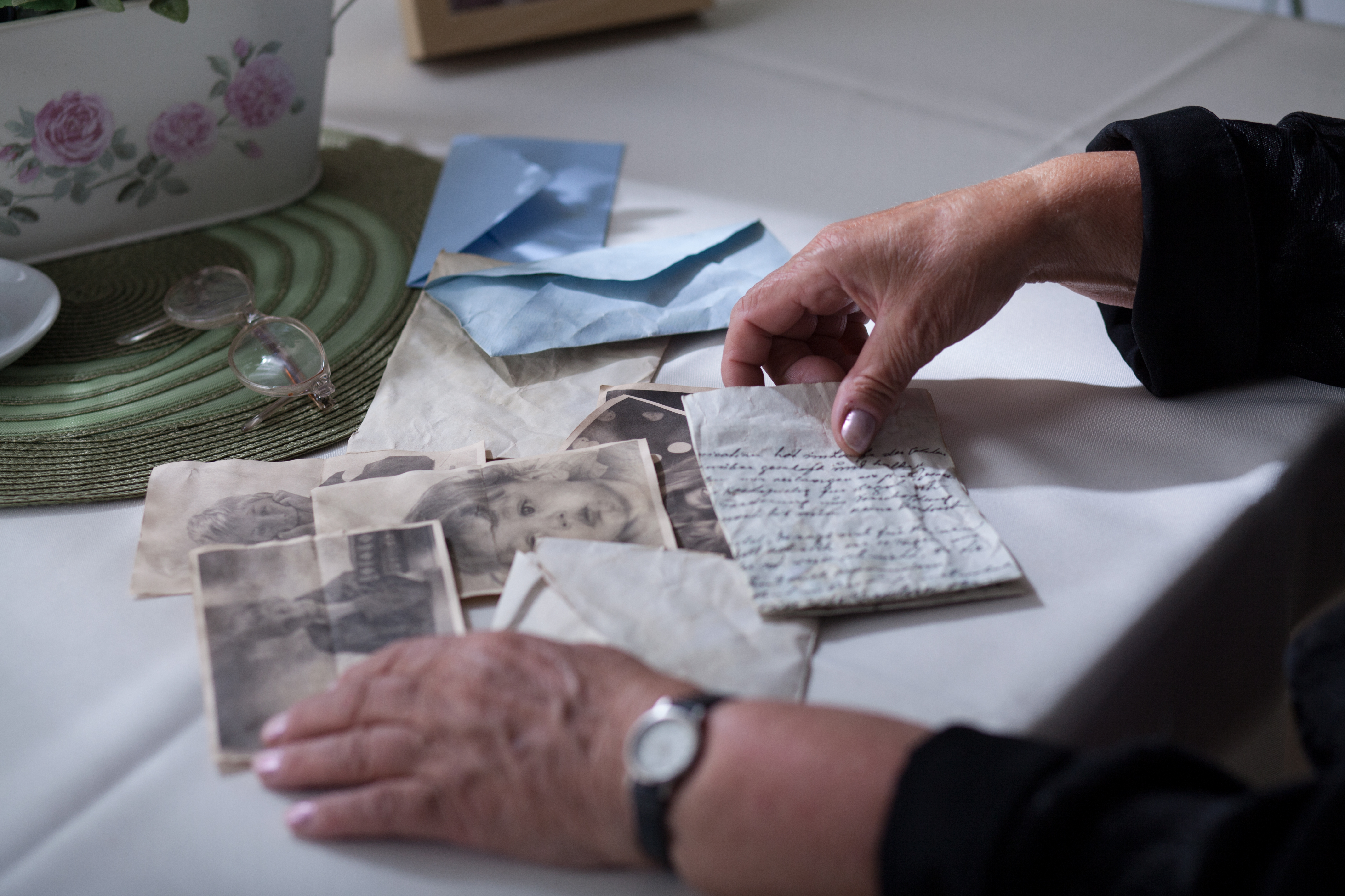 Photos, envelopes, and a letter on a table | Source: Shutterstock