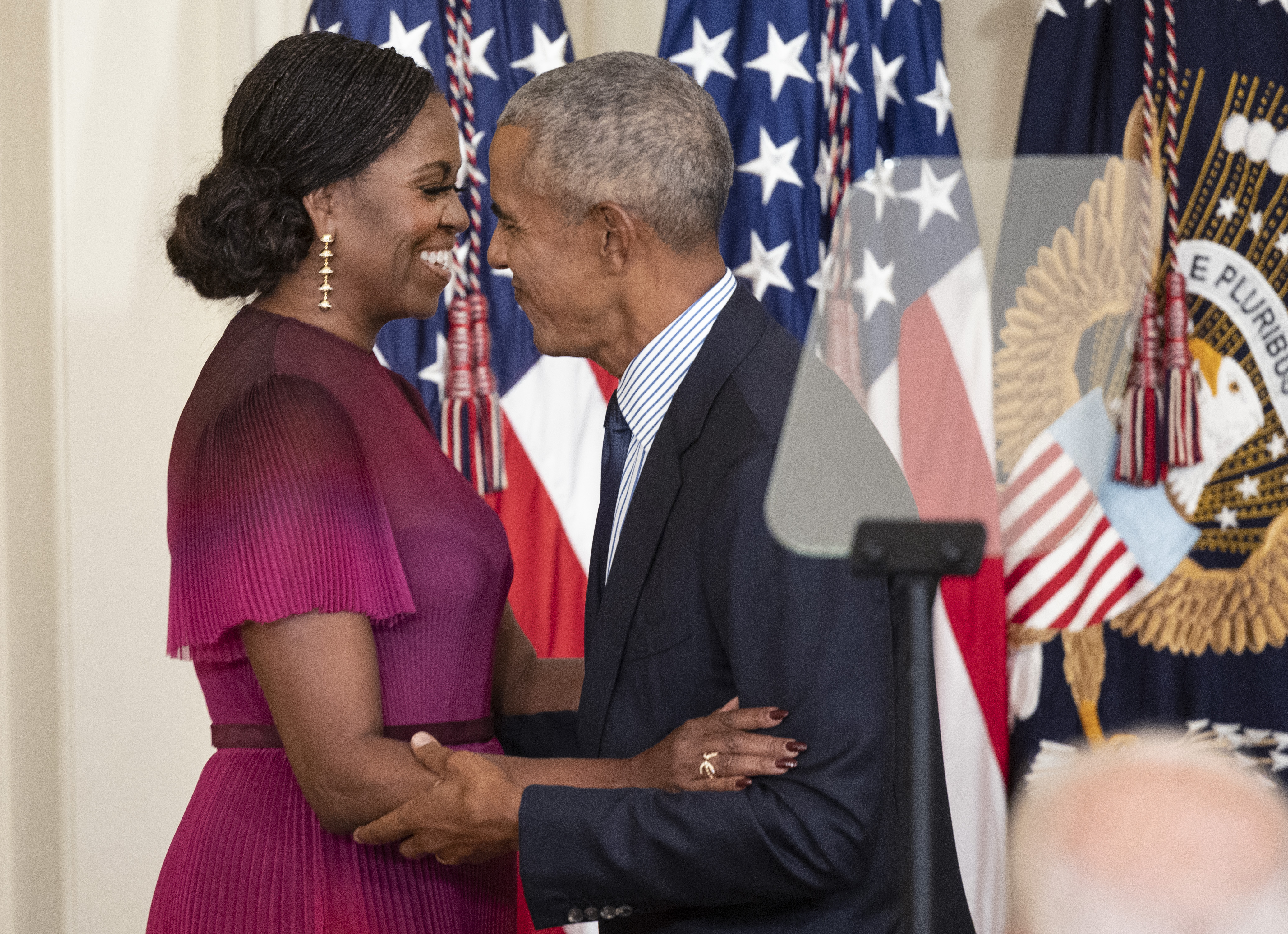 Former First Lady Michelle Obama and former U.S. President Barack Obama embrace at a ceremony to unveil their official White House portraits on September 7, 2022, in Washington, D.C. | Source: Getty Images