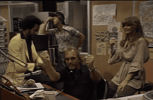 Staff at the WKRP radio station anxious as Les reports the news. | Source: YouTube/Shout! Factory.