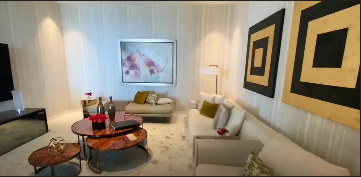 Screenshot of a living room in a model unit with a similar floor plan as David and Victoria Beckham's penthouse | Youtube.com/Miami New Luxury Developments