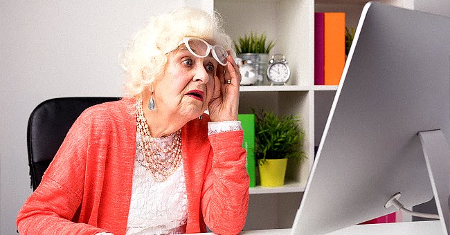 An elderly woman looking at the computer monitor. | Source: Shutterstock