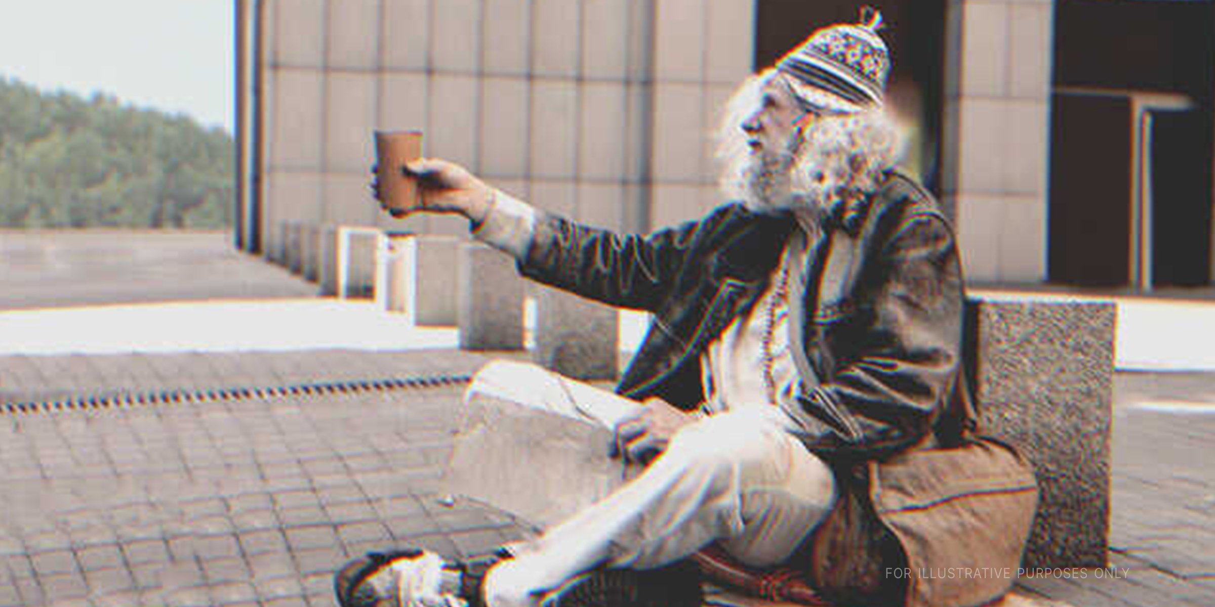 Obdachloser sitzt auf der Straße | Quelle: Shutterstock